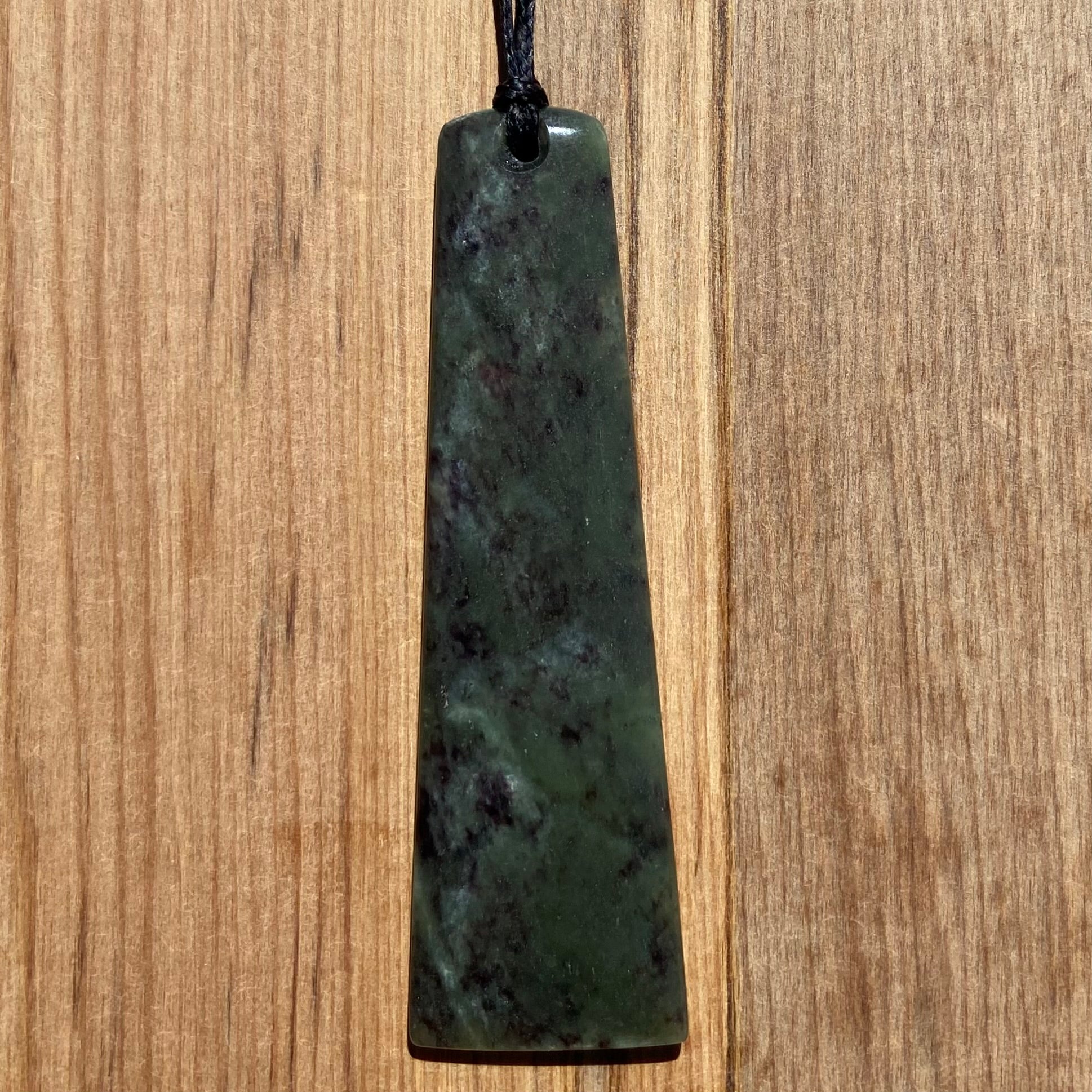 Toki pendant hand-carved from New Zealand totoweka pounamu (greenstone). Back.