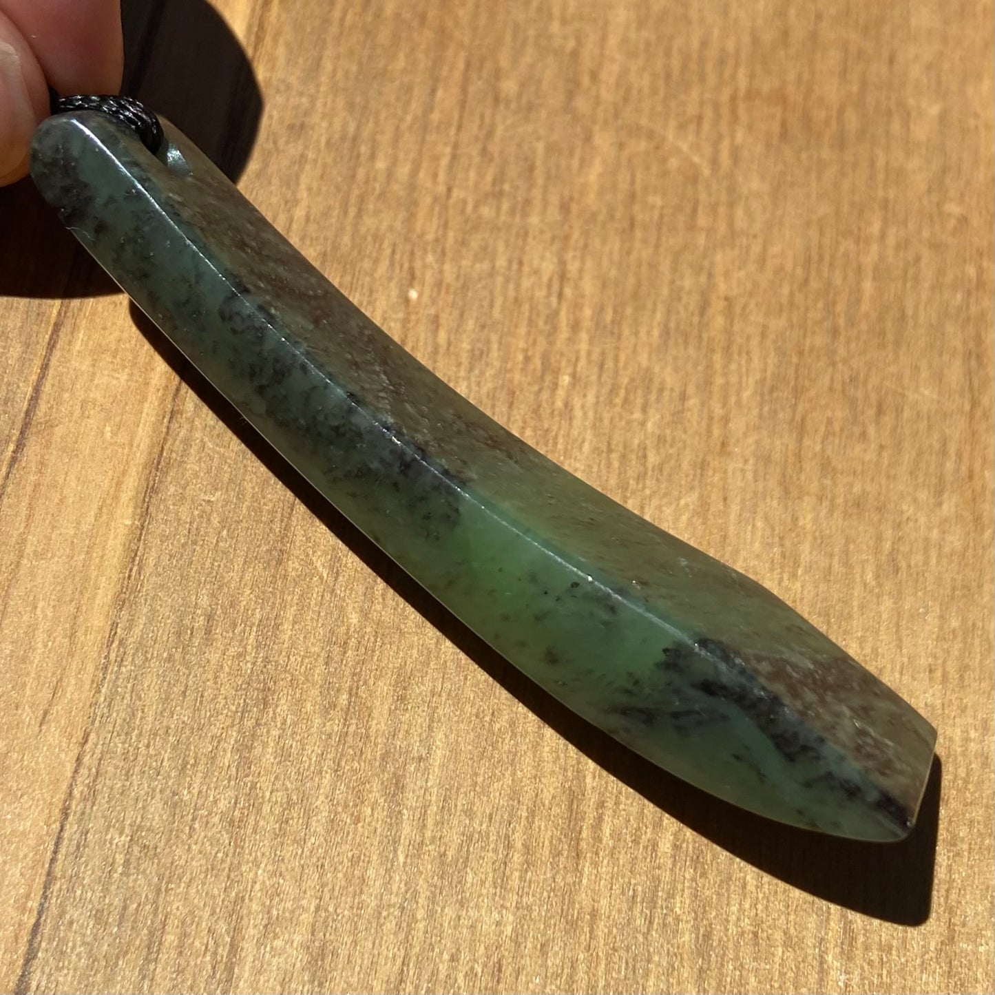 Pounamu toki from New Zealand Kawakawa pounamu (greenstone). Side.