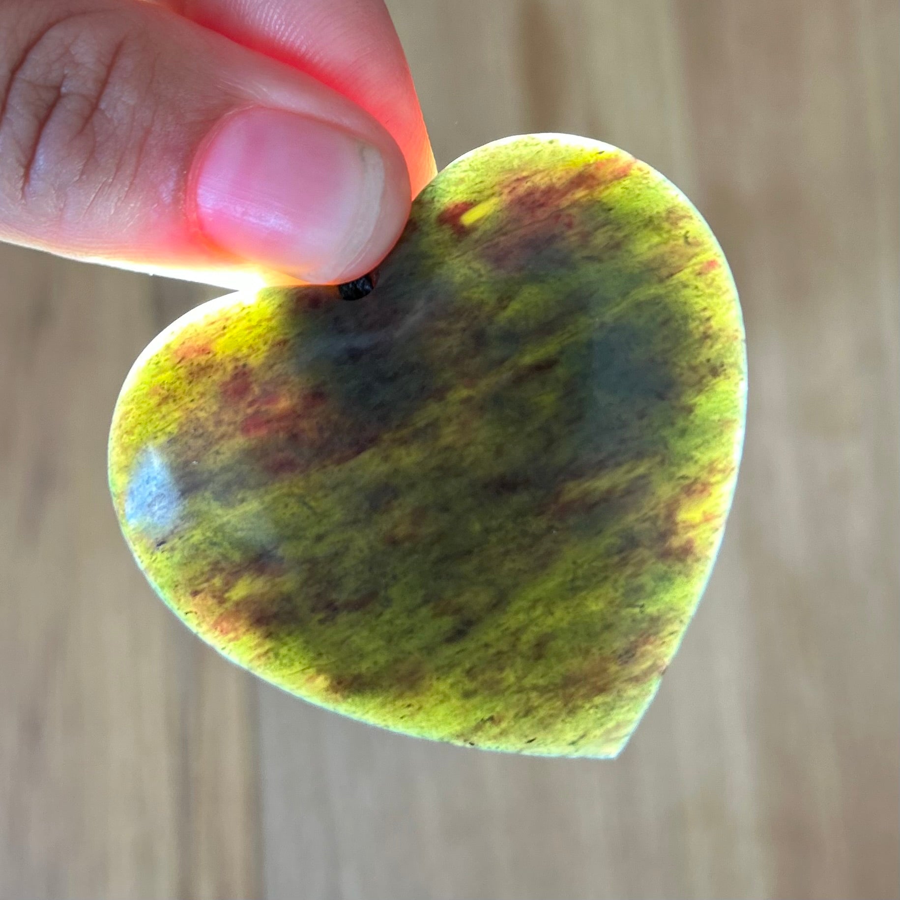 Heart pendant hand-carved from New Zealand totoweka pounamu (greenstone). Translucency.