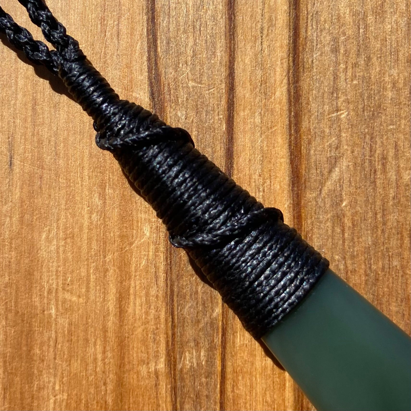 Bound roimata teardrop pendant carved from New Zealand inanga pounamu (greenstone). Binding.