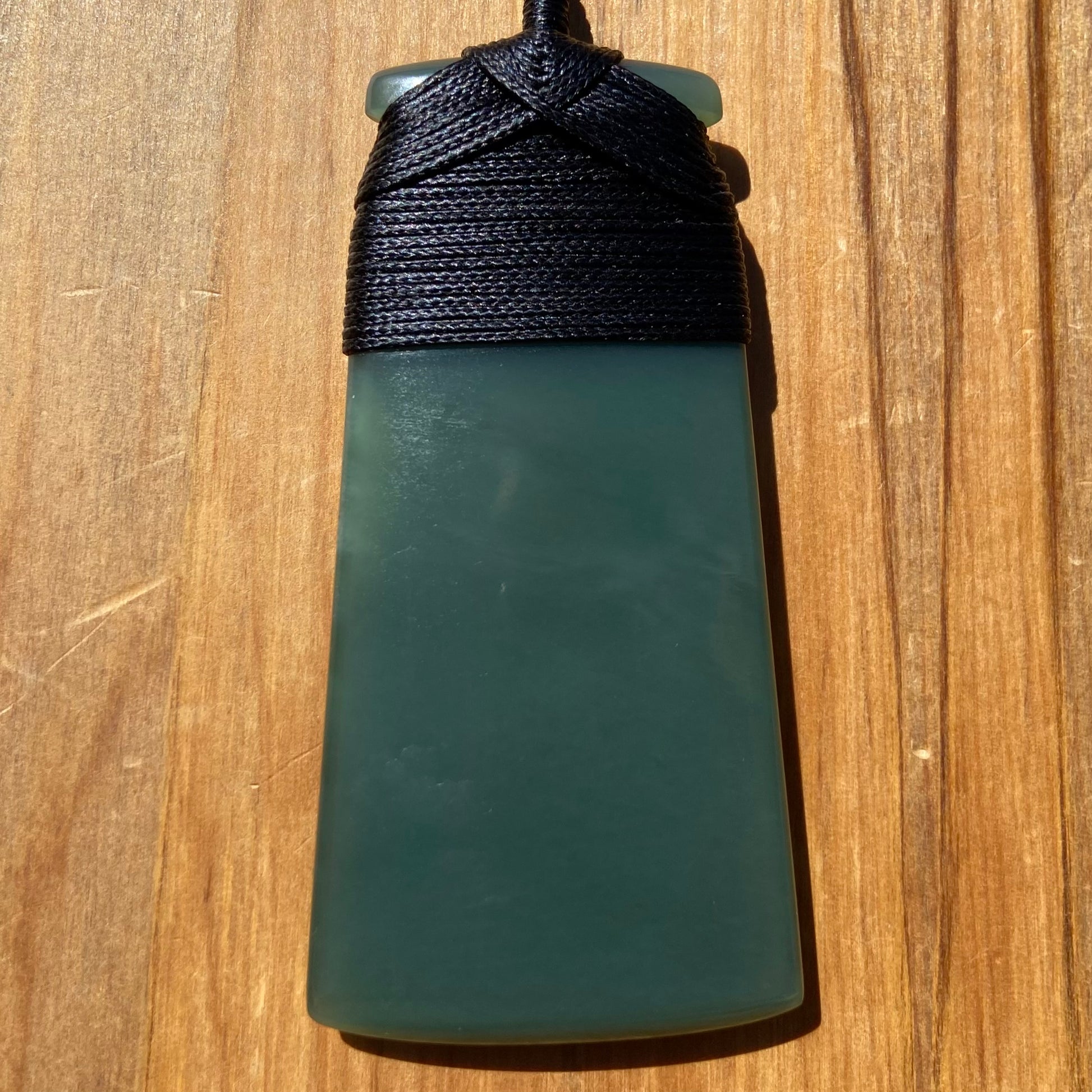 Bound toki pendant hand-carved from New Zealand inanga pounamu (greenstone). Front.