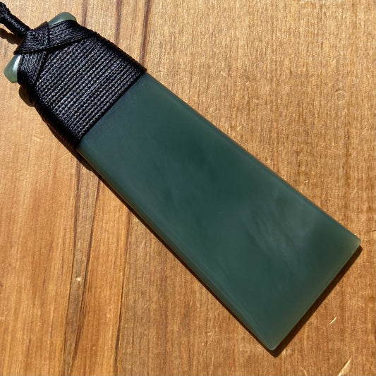 Bound toki pendant hand-carved from New Zealand inanga pounamu (greenstone). Front.