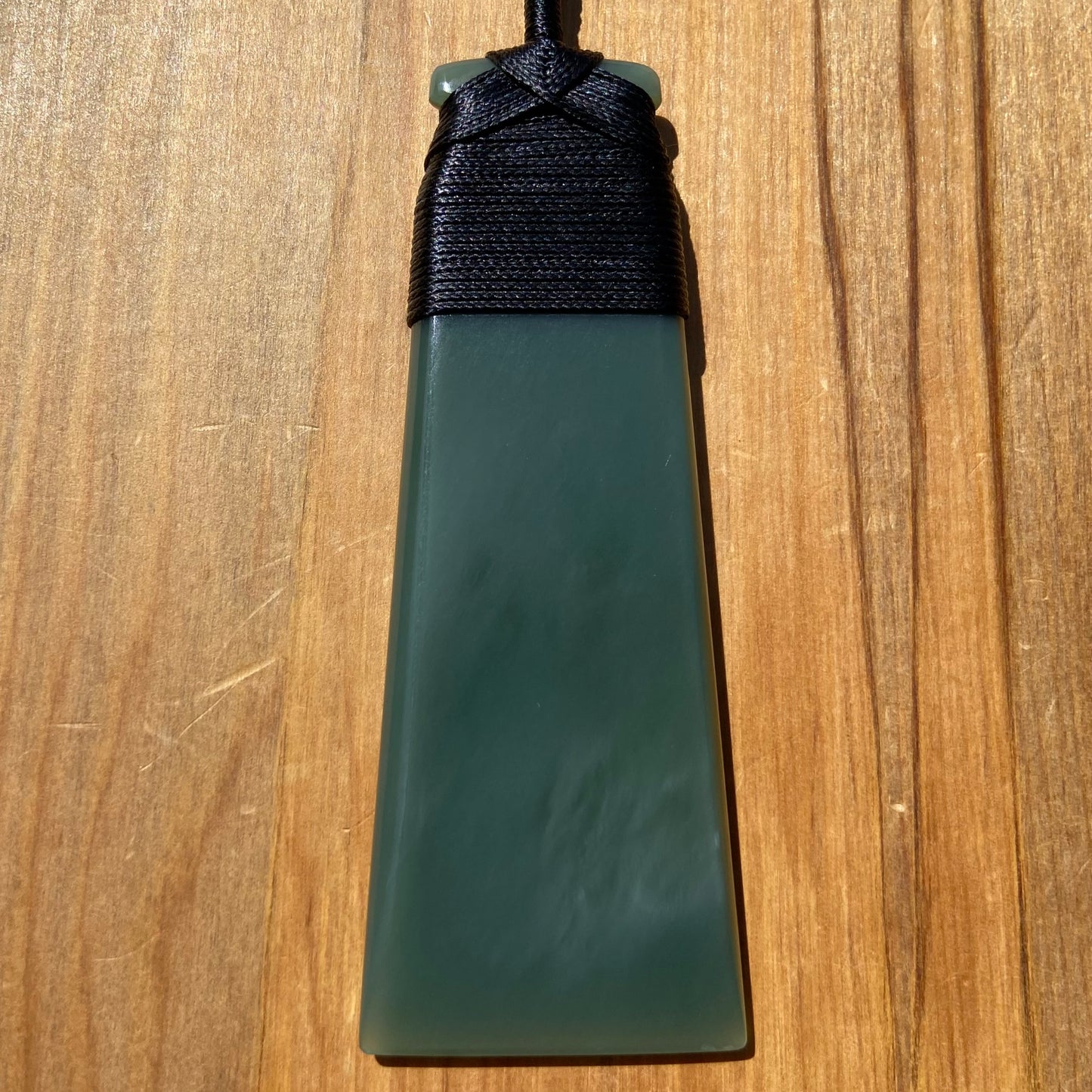 Bound toki pendant hand-carved from New Zealand inanga pounamu (greenstone). Front.