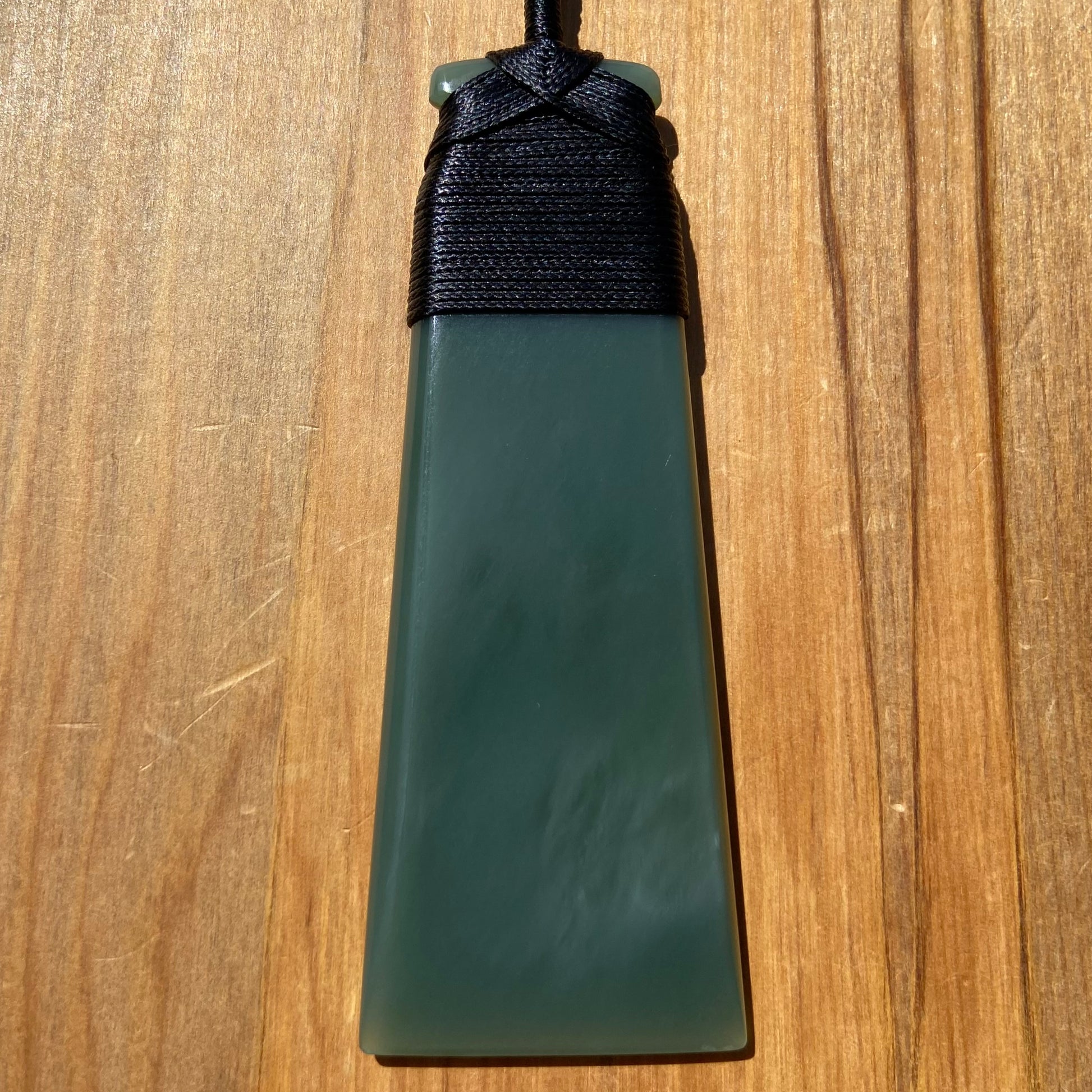 Bound toki pendant hand-carved from New Zealand inanga pounamu (greenstone). Front.