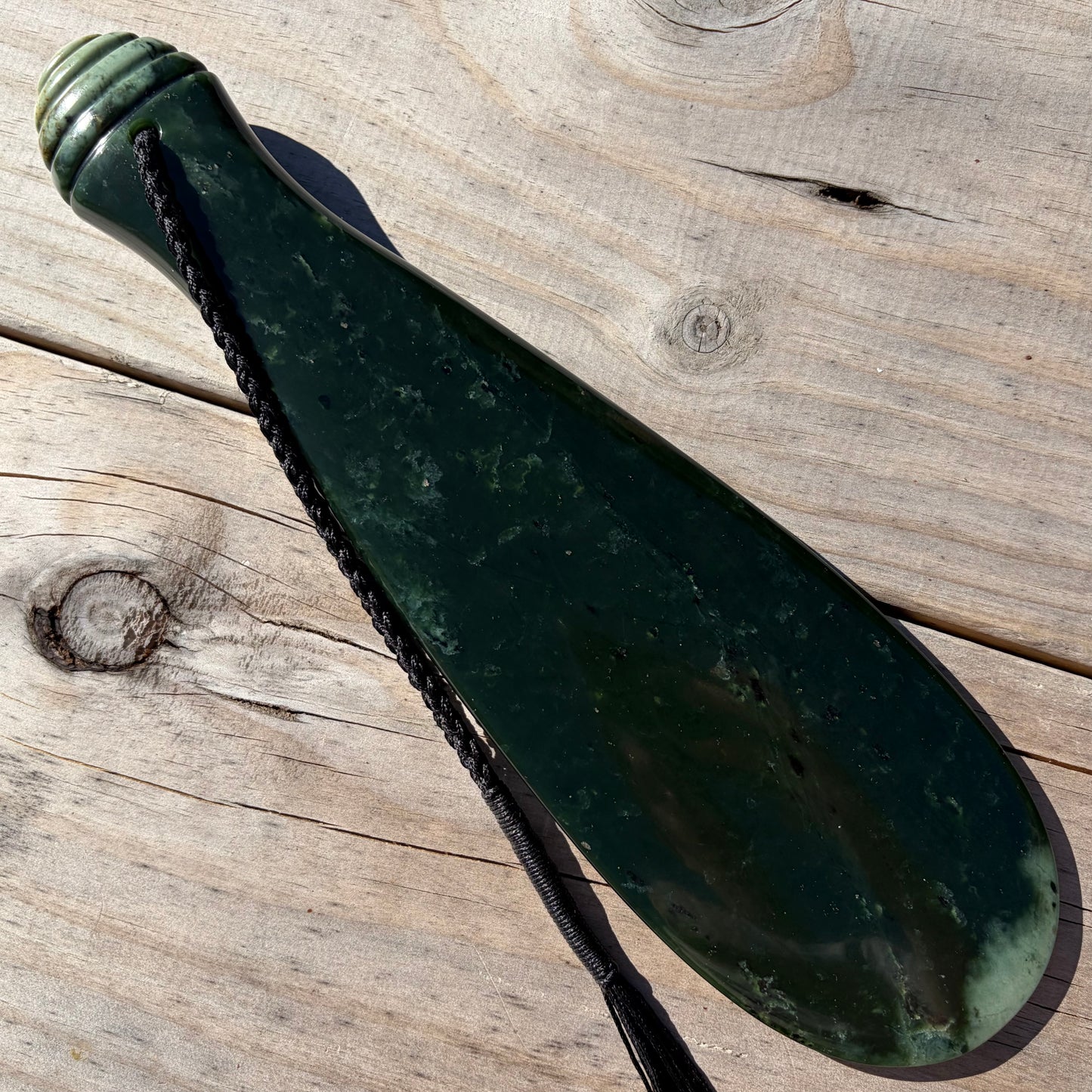 Mere / Patu  hand-carved from New Zealand Kawakawa pounamu (greenstone). Front.