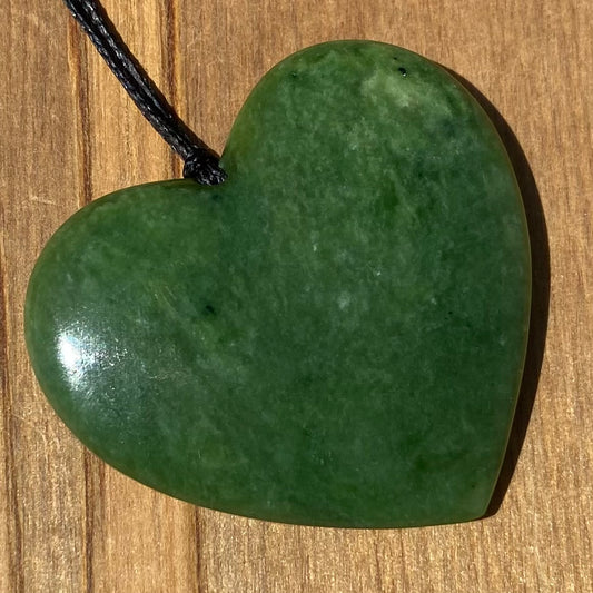 Heart shape pendant carved from New Zealand Marsden Flower Jade (greenstone). Front.