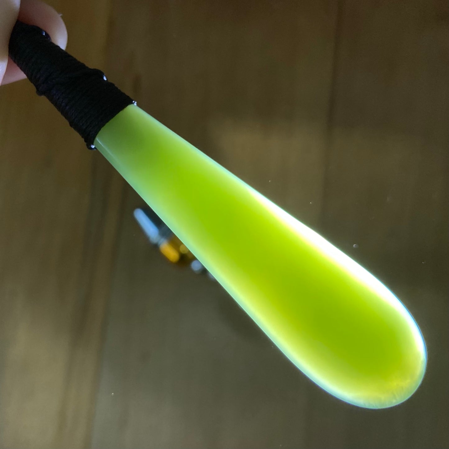 Bound roimata teardrop pendant carved from New Zealand inanga pounamu (greenstone). Translucency.