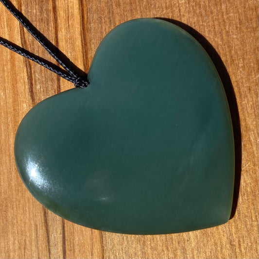 Large heart shaped pendant hand-carved from New Zealand inanga pounamu (greenstone). Front.