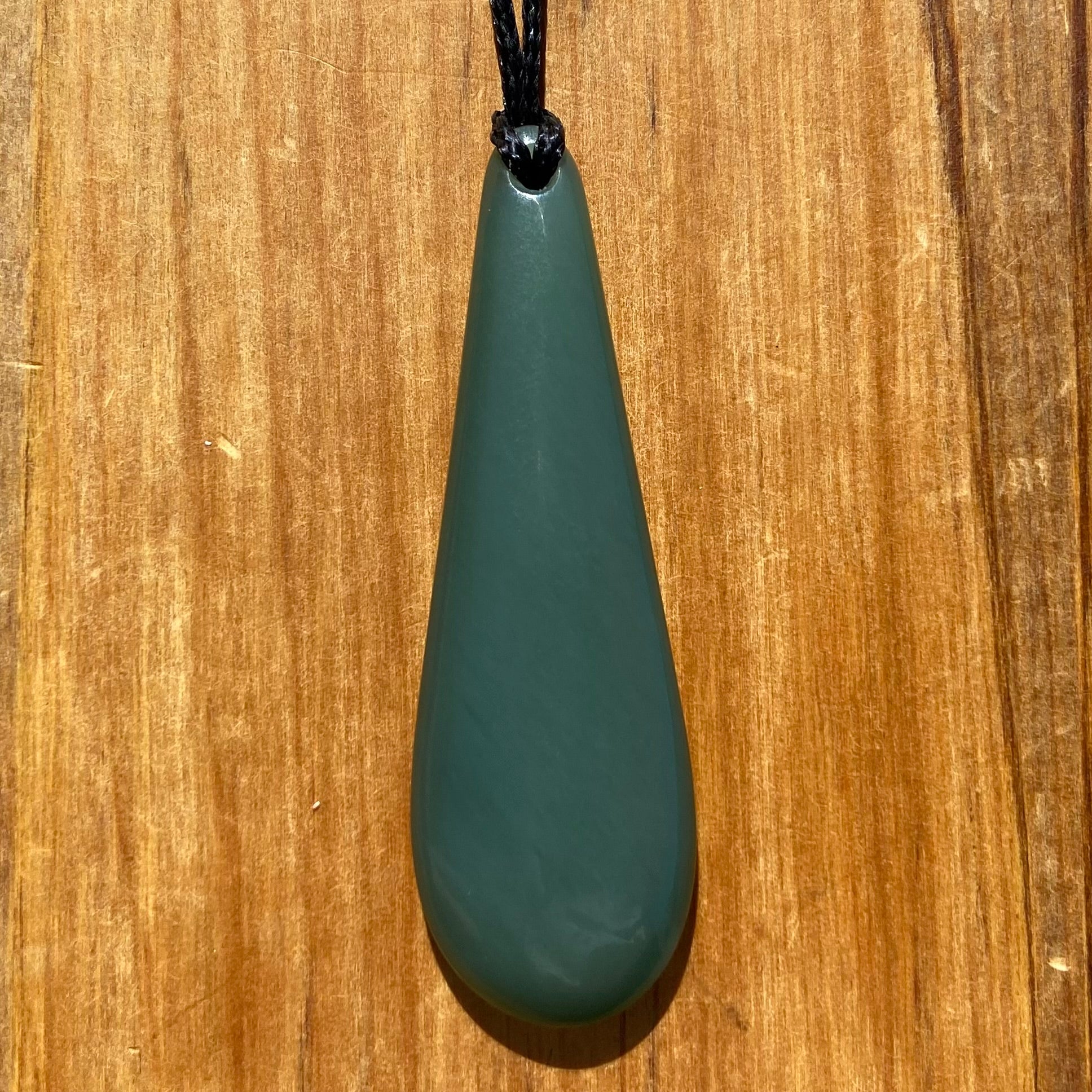 Roimata teardrop pendant carved from New Zealand inanga pounamu (greenstone). Front.
