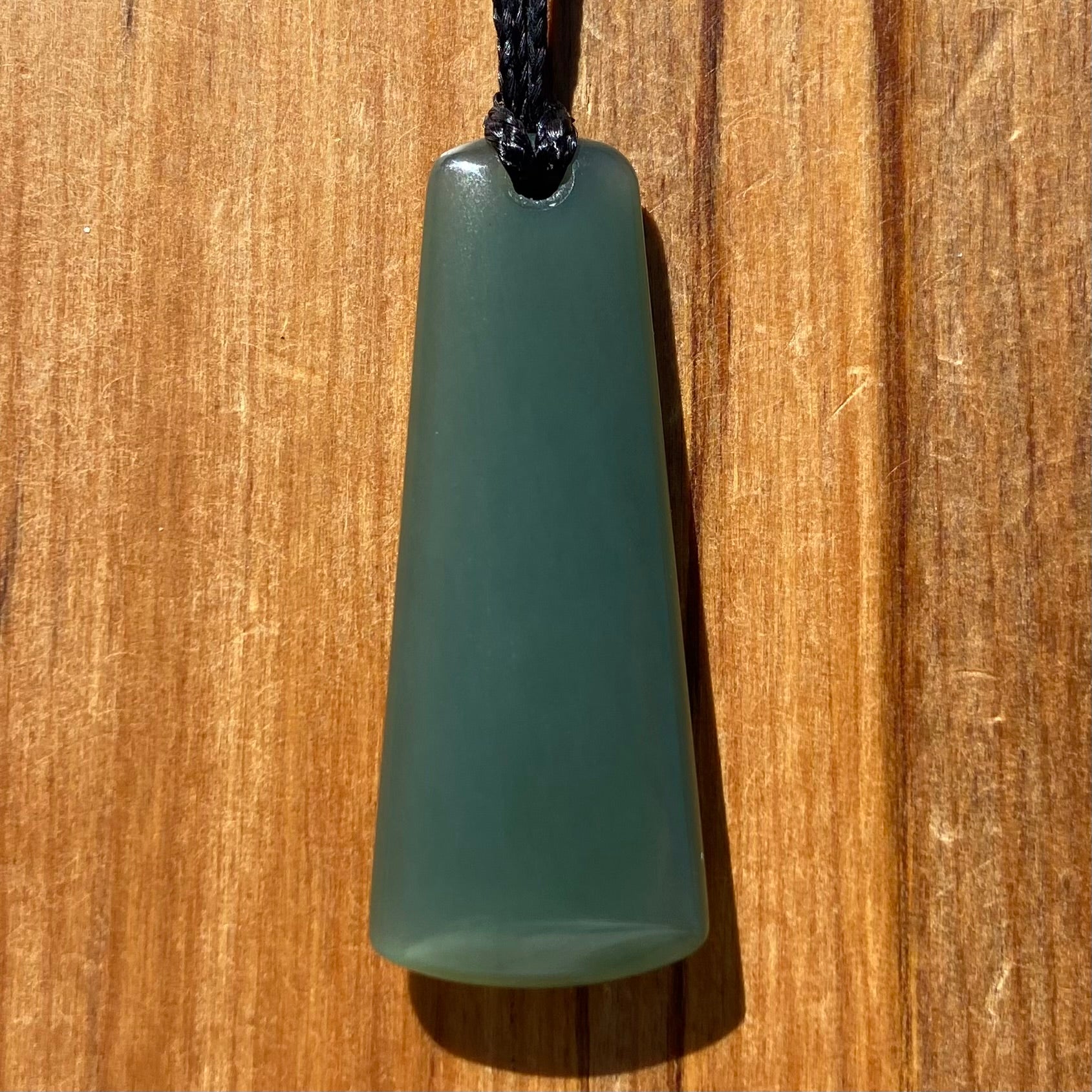 Toki pendant hand-carved from New Zealand inanga pounamu (greenstone). Front.