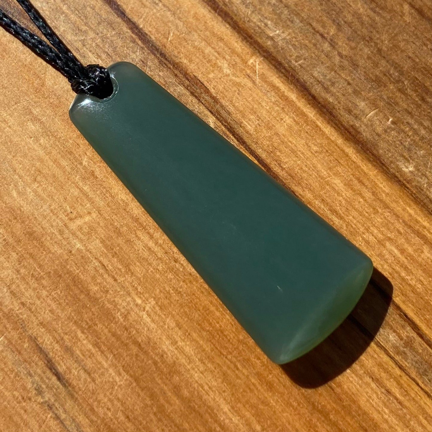 Toki pendant hand-carved from New Zealand inanga pounamu (greenstone). Front.