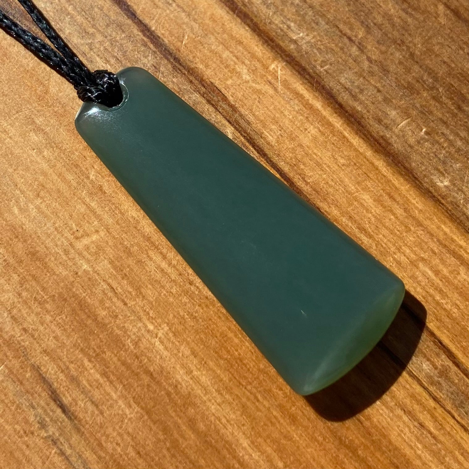 Toki pendant hand-carved from New Zealand inanga pounamu (greenstone). Front.
