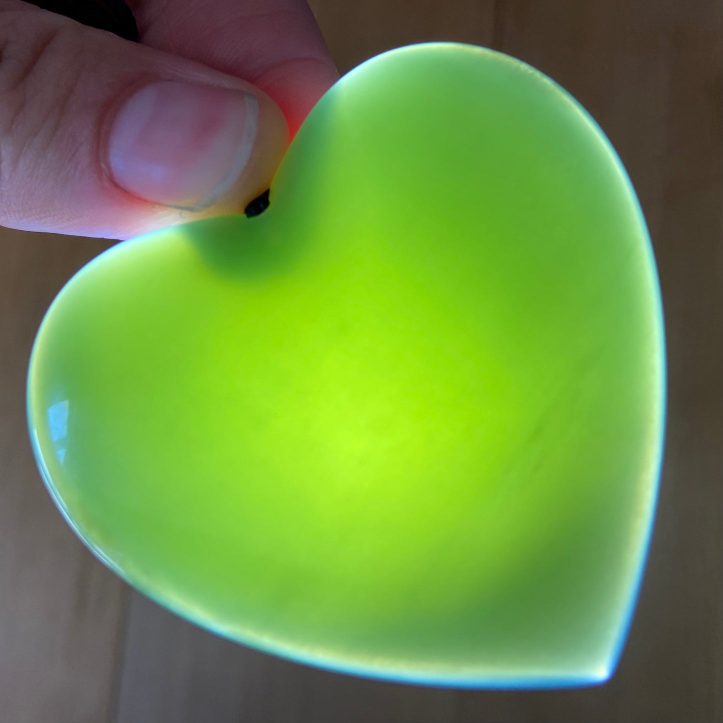 Large heart shaped pendant hand-carved from New Zealand inanga pounamu (greenstone). Translucency. 