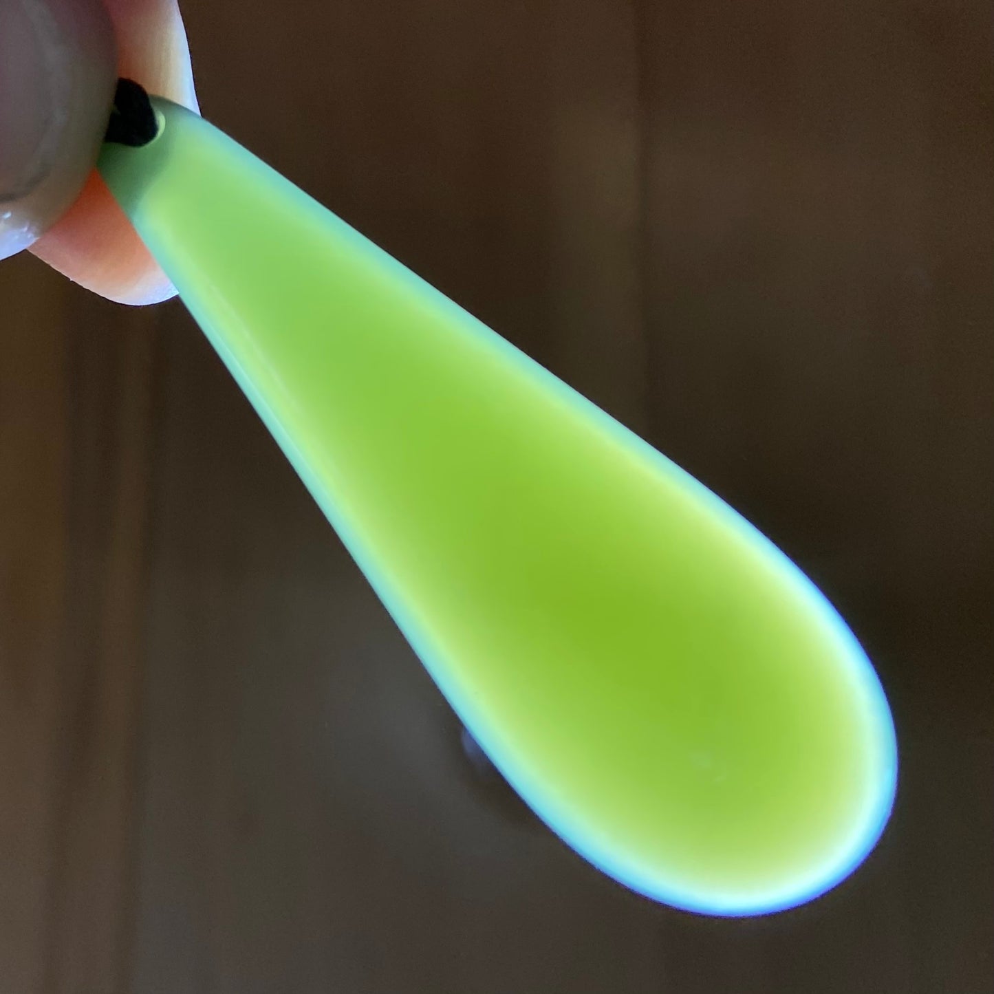 Roimata teardrop pendant carved from New Zealand inanga pounamu (greenstone). Translucency.