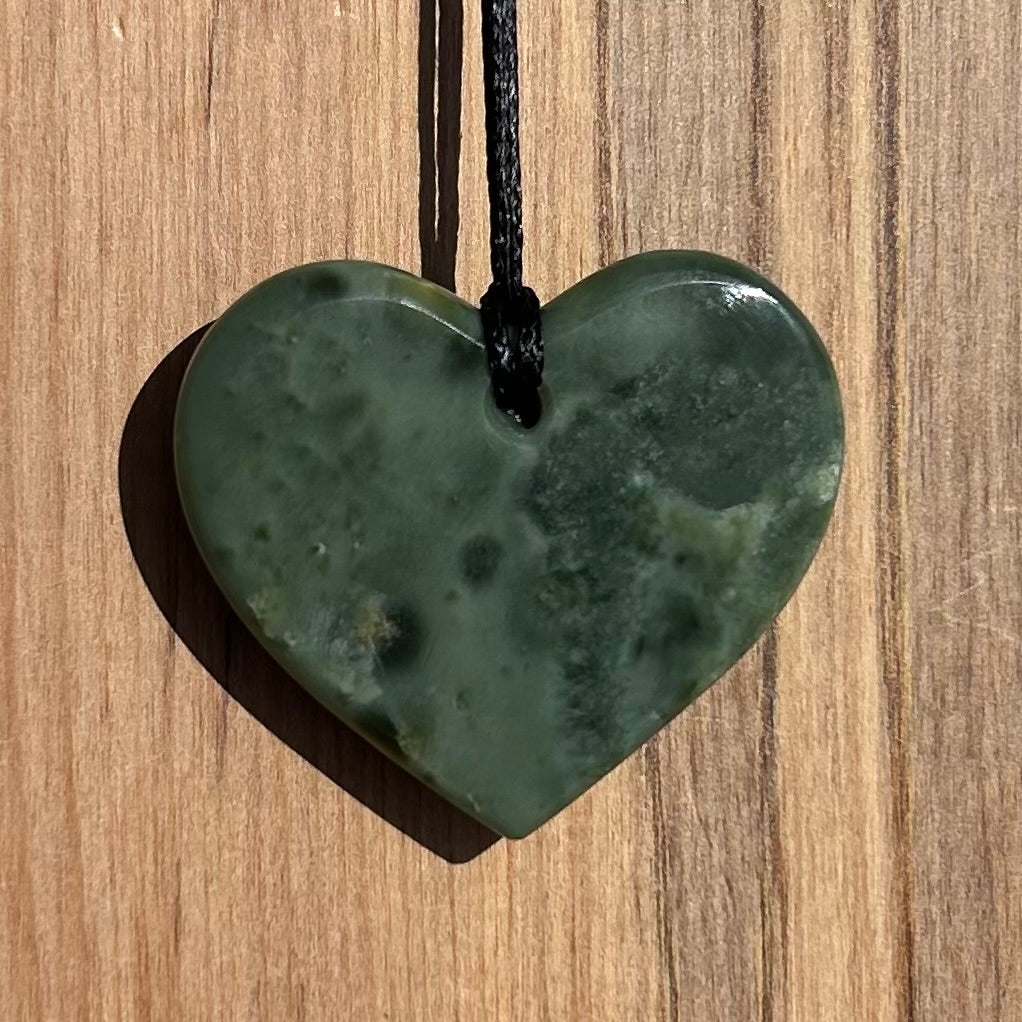 Heart shaped pendant hand-carved from New Zealand inanga pounamu (greenstone). Back.