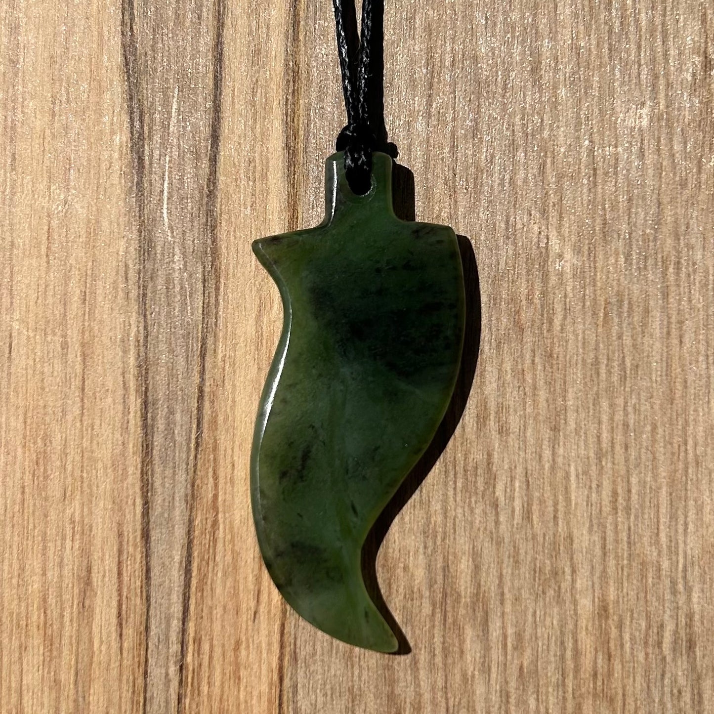 Fern pendant hand-carved from New Zealand kawawkawa pounamu (greenstone). Back.