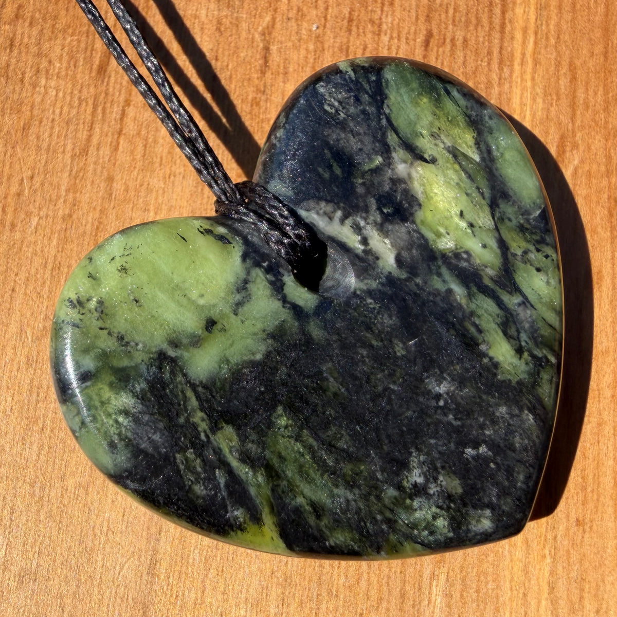Heart pendant hand-carved from New Zealand Douglas Creek pounamu (greenstone). Back.
