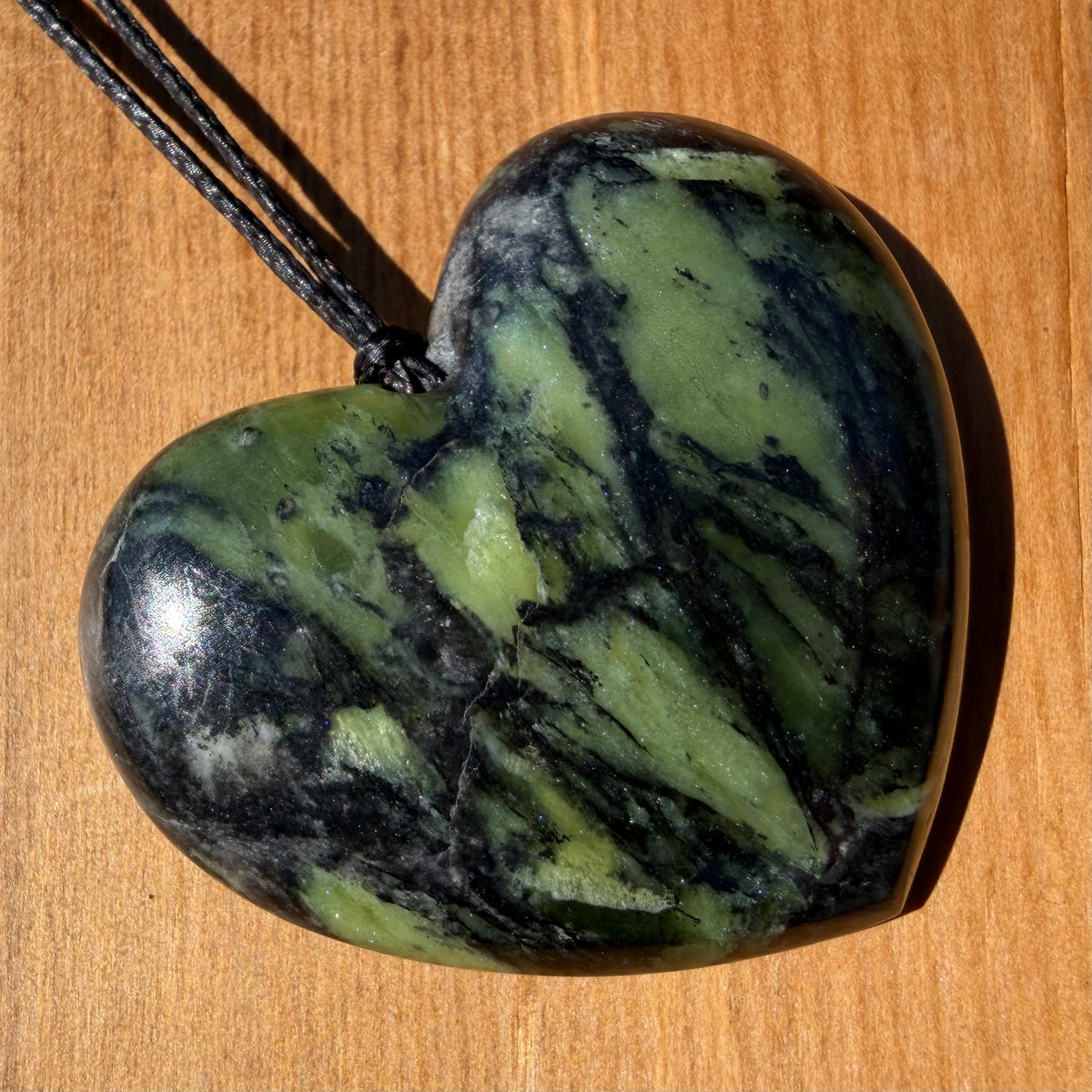 Heart pendant hand-carved from New Zealand Douglas Creek pounamu (greenstone). Front.