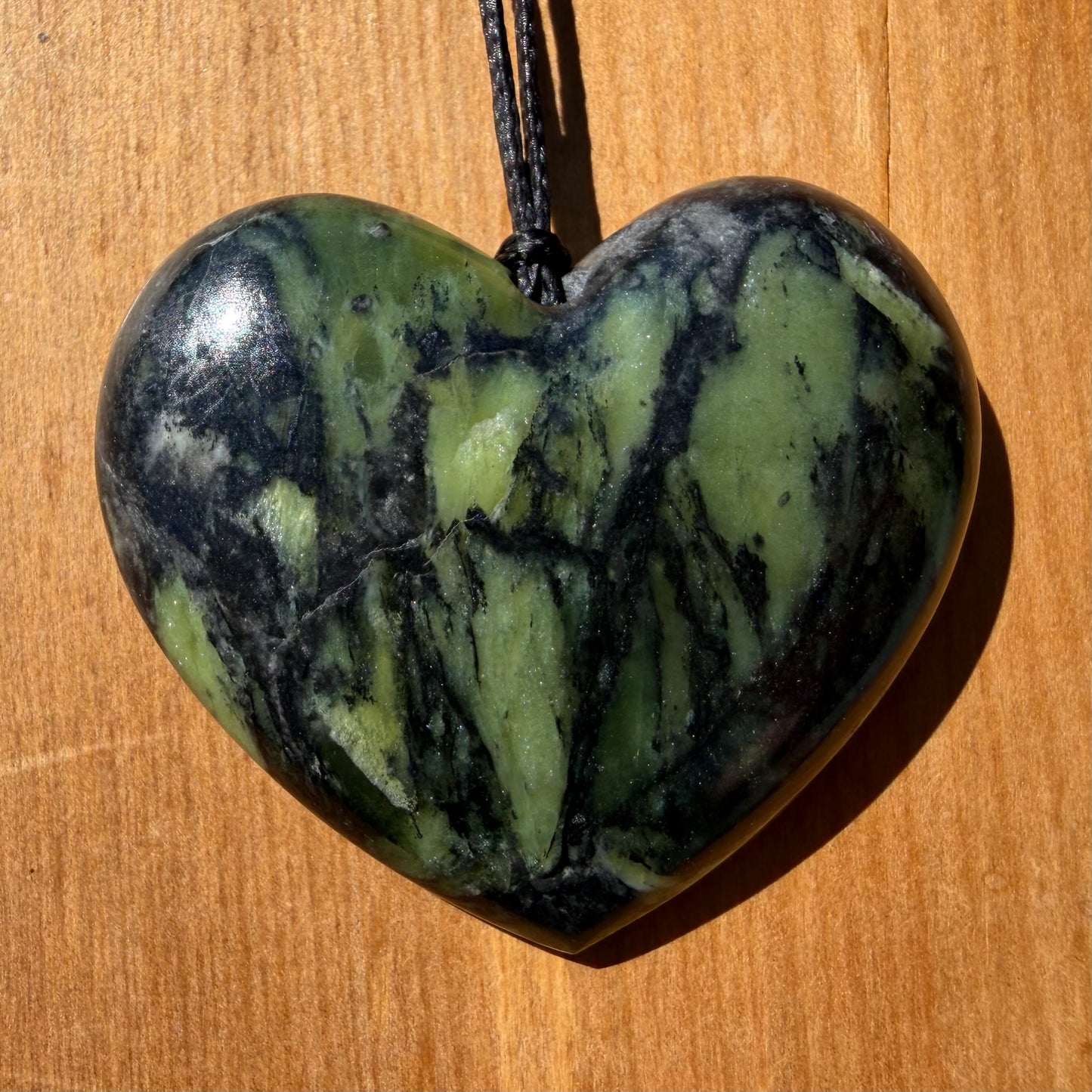 Heart pendant hand-carved from New Zealand Douglas Creek pounamu (greenstone). Front.
