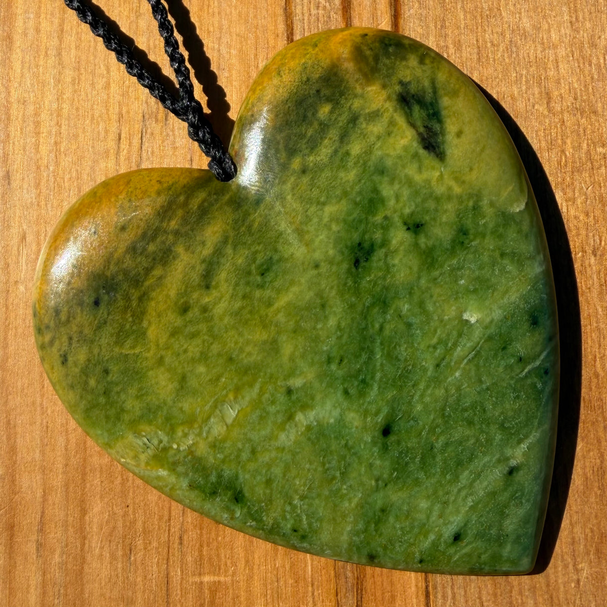 Pounamu heart shaped pendant carved from New Zealand Marsden Flower Jade (greenstone). Front. Extra Large
