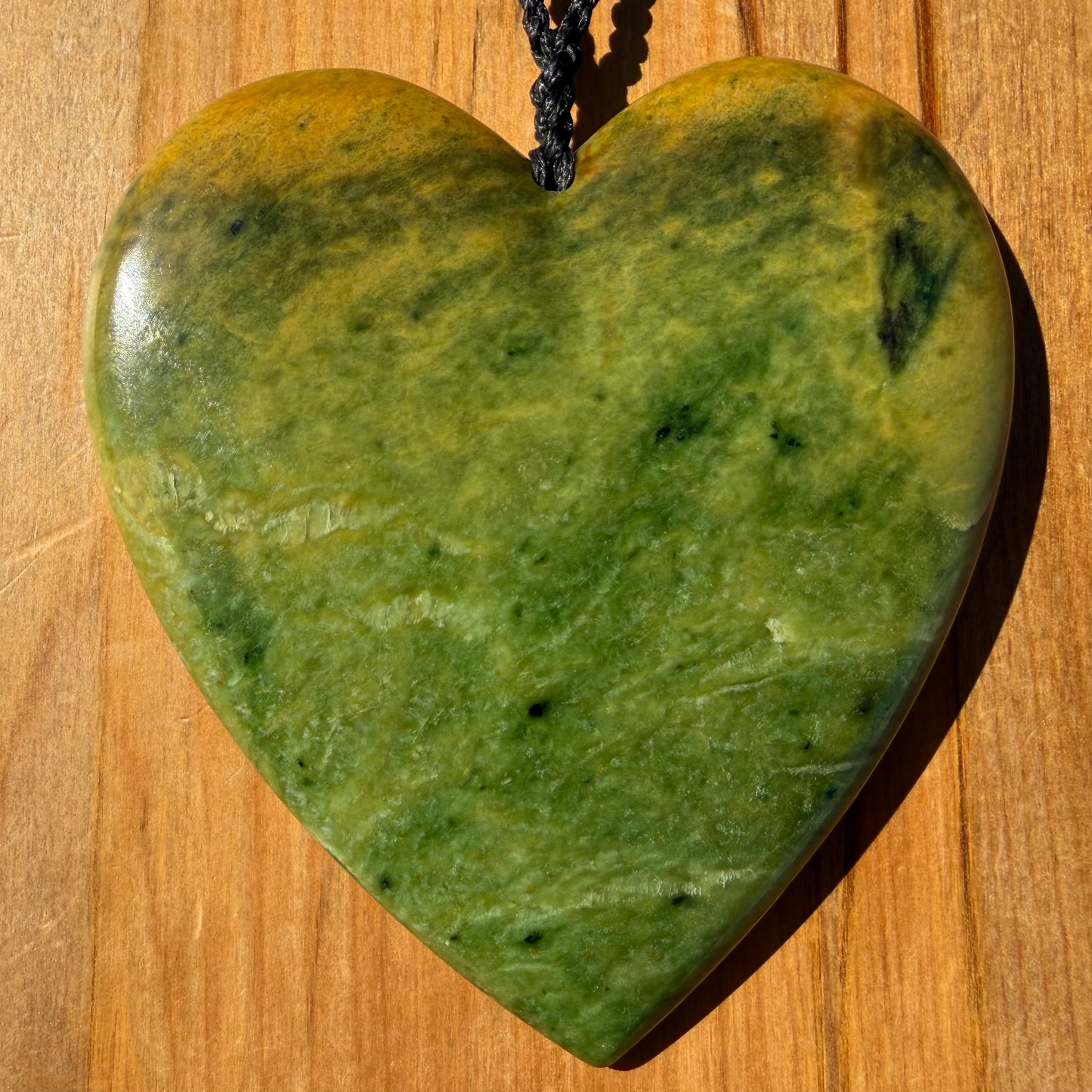 Pounamu heart shaped pendant carved from New Zealand Marsden Flower Jade (greenstone). Front. Extra Large