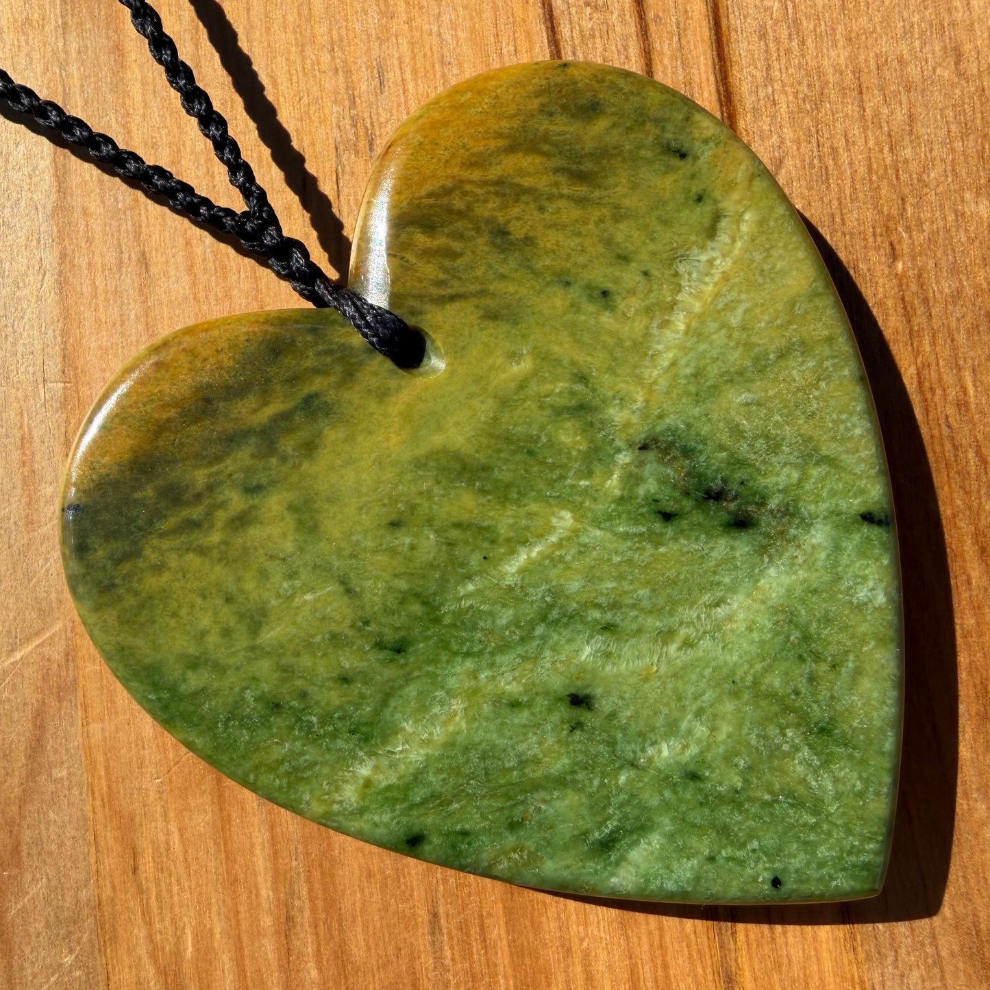 XL Pounamu heart shaped pendant carved from New Zealand Marsden Flower Jade (greenstone). Back.