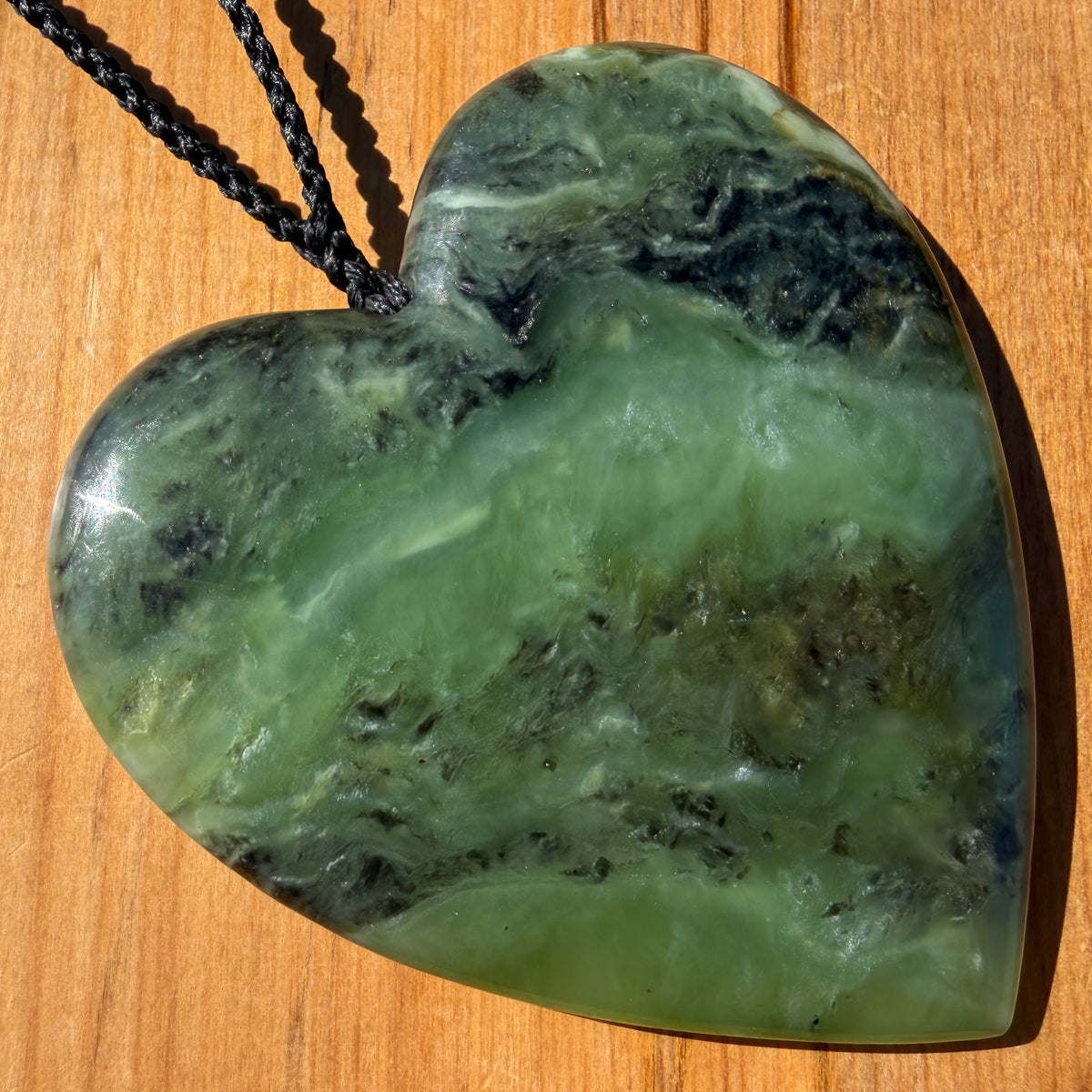 XL Heart pendant hand-carved from New Zealand kawawkawa pounamu (greenstone). Front.