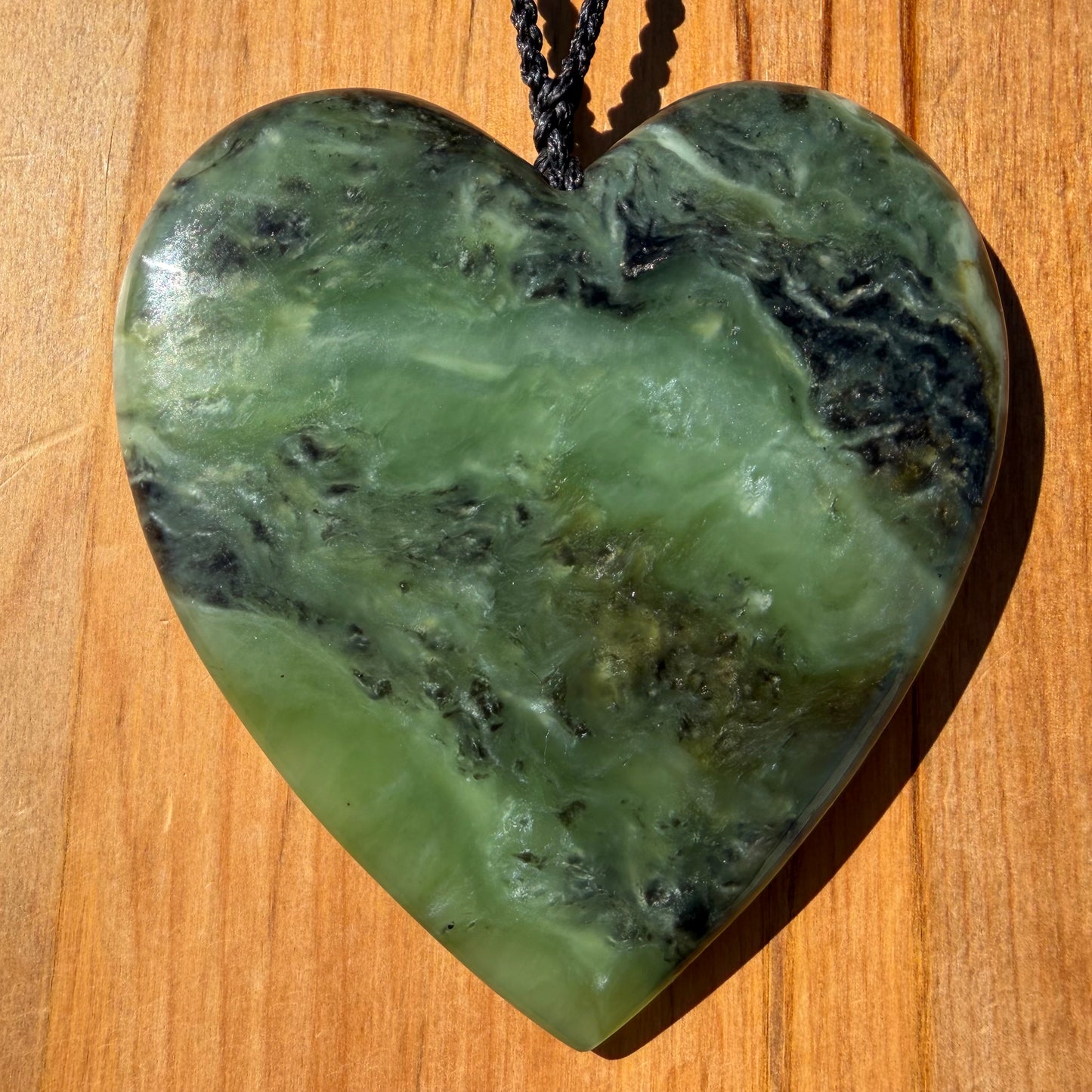 Extra large heart pendant hand-carved from New Zealand kawawkawa pounamu (greenstone). Front.