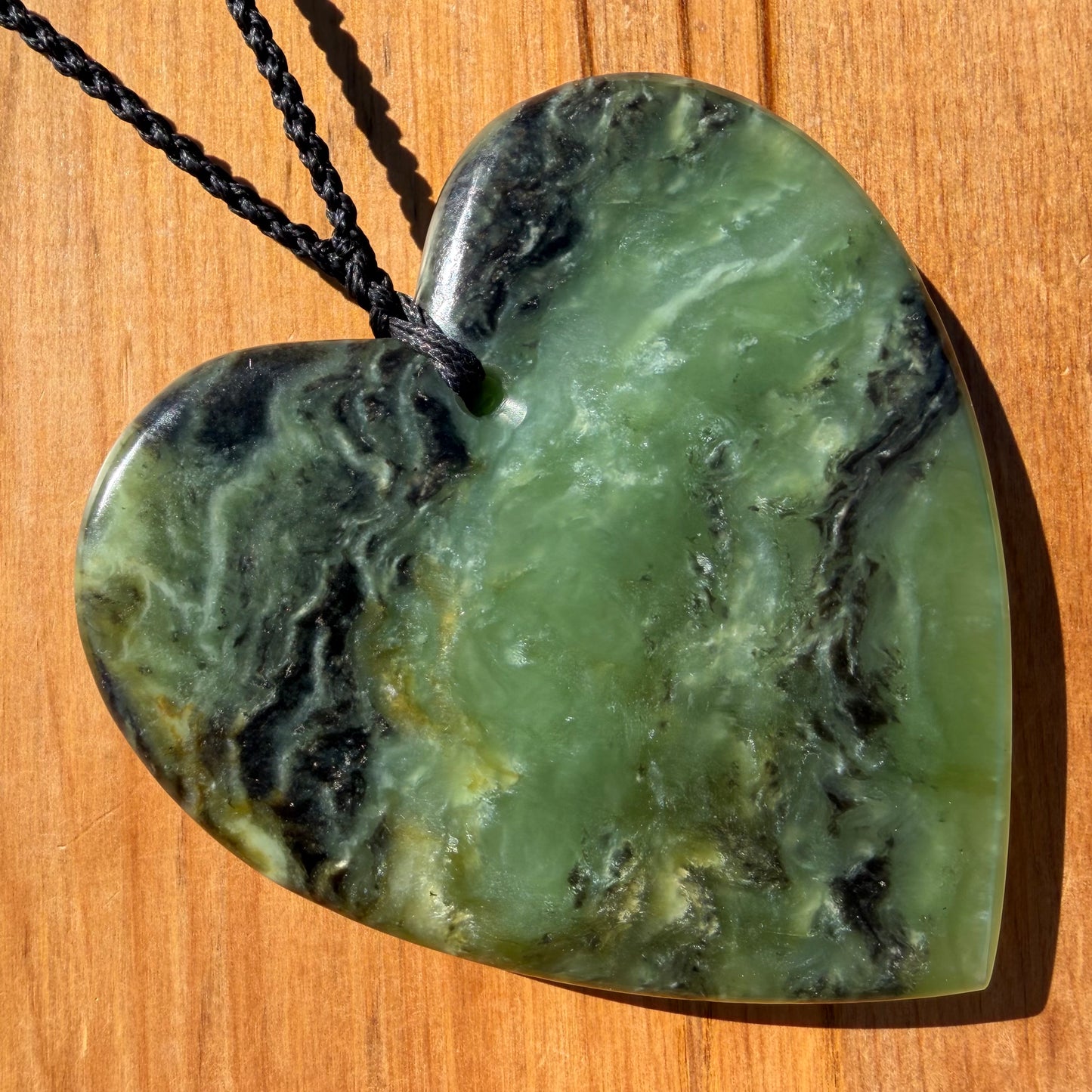 Heart pendant hand-carved from New Zealand kawawkawa pounamu (greenstone). Back.