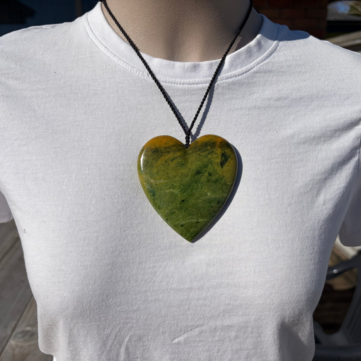 Pounamu heart shaped pendant carved from New Zealand Marsden Flower Jade (greenstone). Front. Extra Large heart.