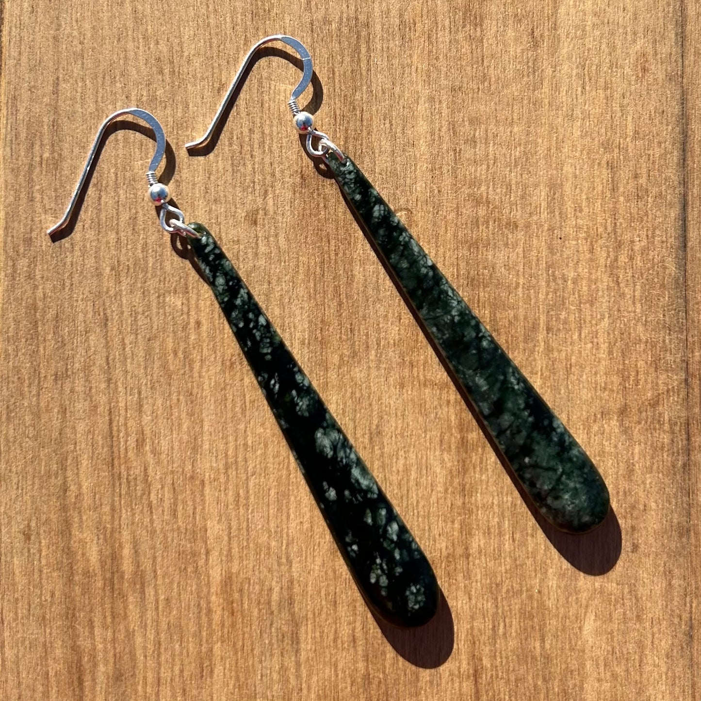 Pair of roimata (teardrop) earrings hand-carved from New Zealand tangiwai pounamu (greenstone), with sterling silver fittings. Back.