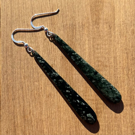 Pair of roimata (teardrop) earrings hand-carved from New Zealand tangiwai  pounamu (greenstone), with sterling silver fittings. Front.