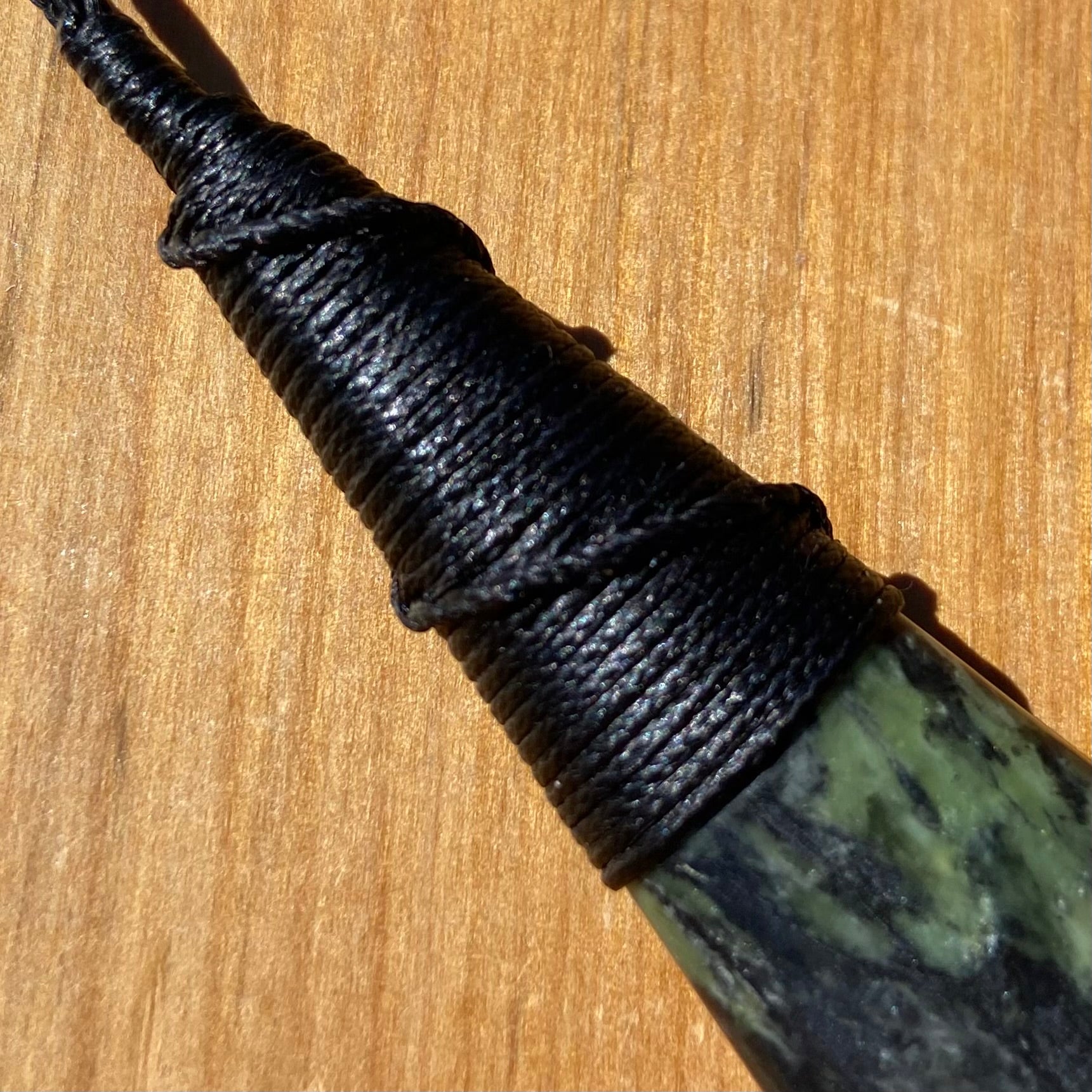 Bound roimata (teardrop) pendant hand-carved from New Zealand Douglas Creek pounamu (greenstone). Binding.