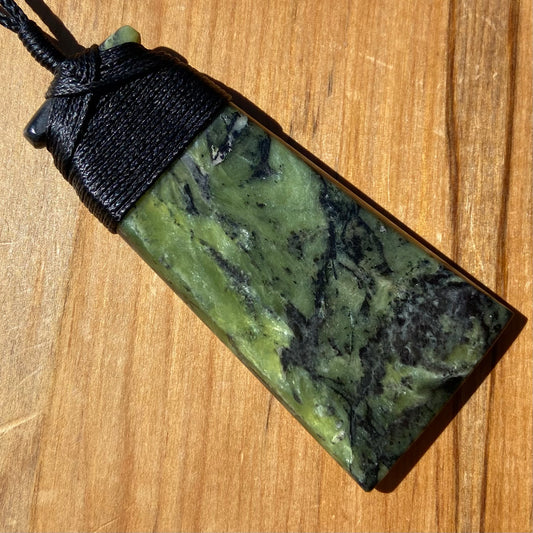 Bound toki pendant hand-carved from New Zealand Douglas Creek pounamu (greenstone). Front.