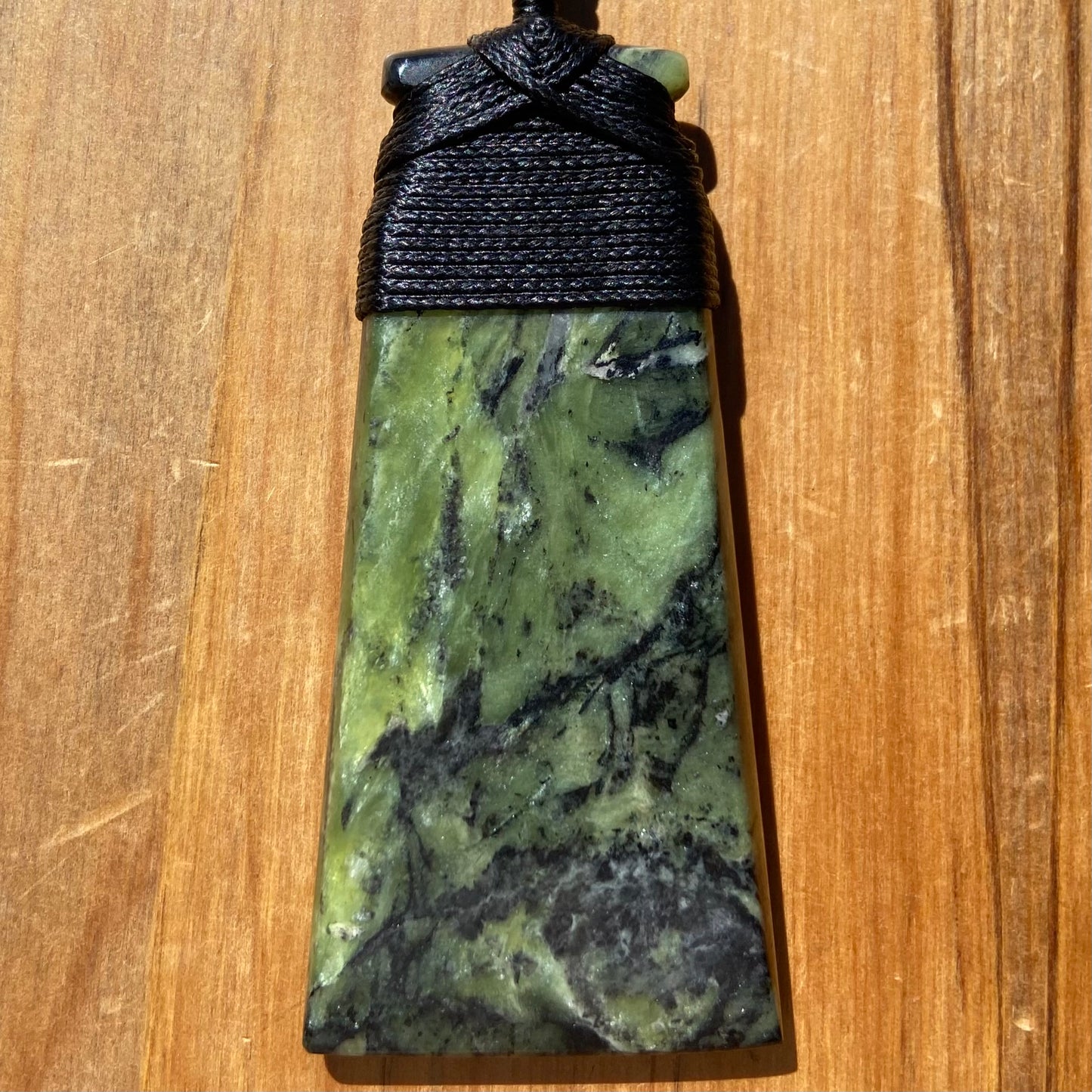 Bound toki pendant hand-carved from New Zealand Douglas Creek pounamu (greenstone). Front.