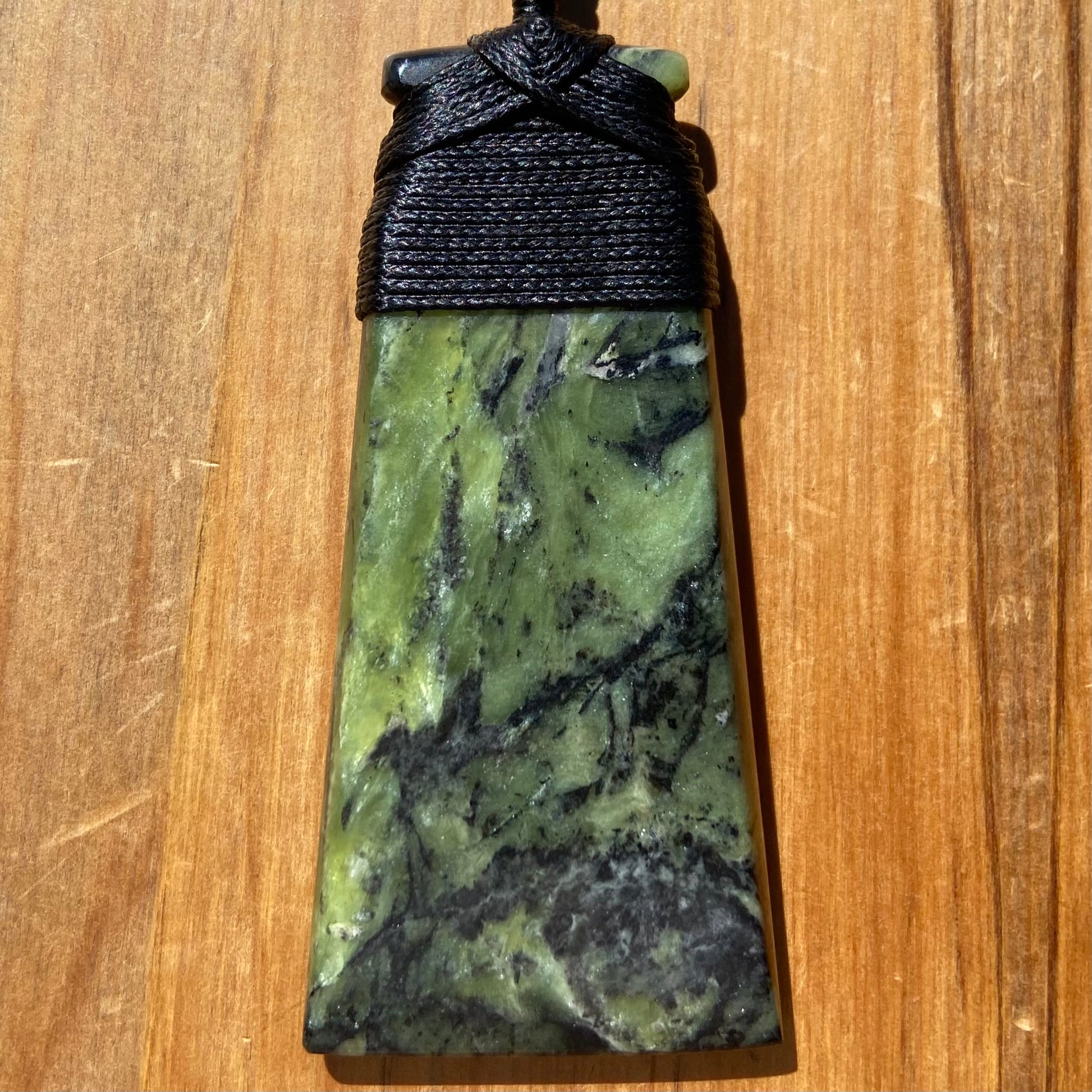 Bound toki pendant hand-carved from New Zealand Douglas Creek pounamu (greenstone). Front.