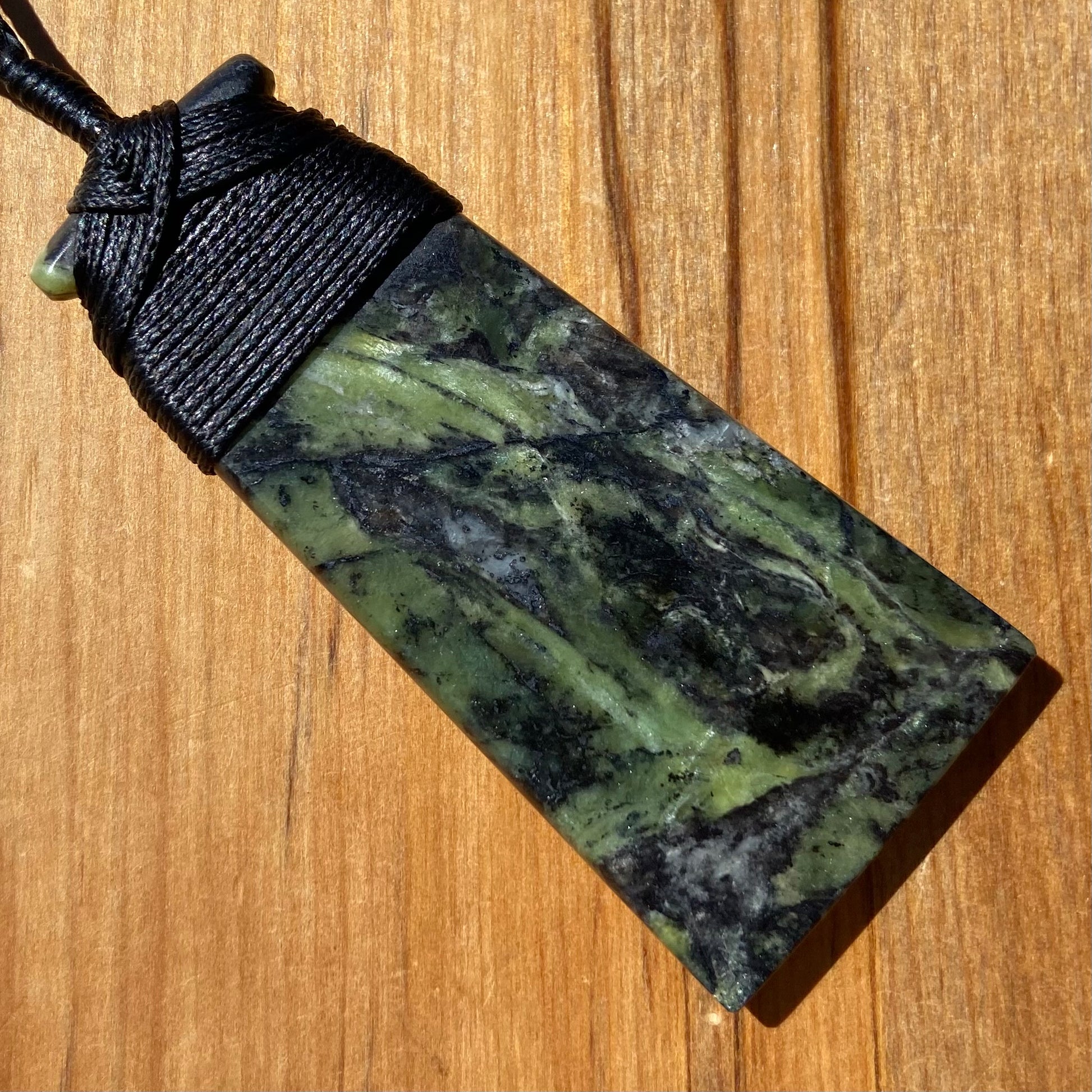 Bound toki pendant hand-carved from New Zealand Douglas Creek pounamu (greenstone). Back.