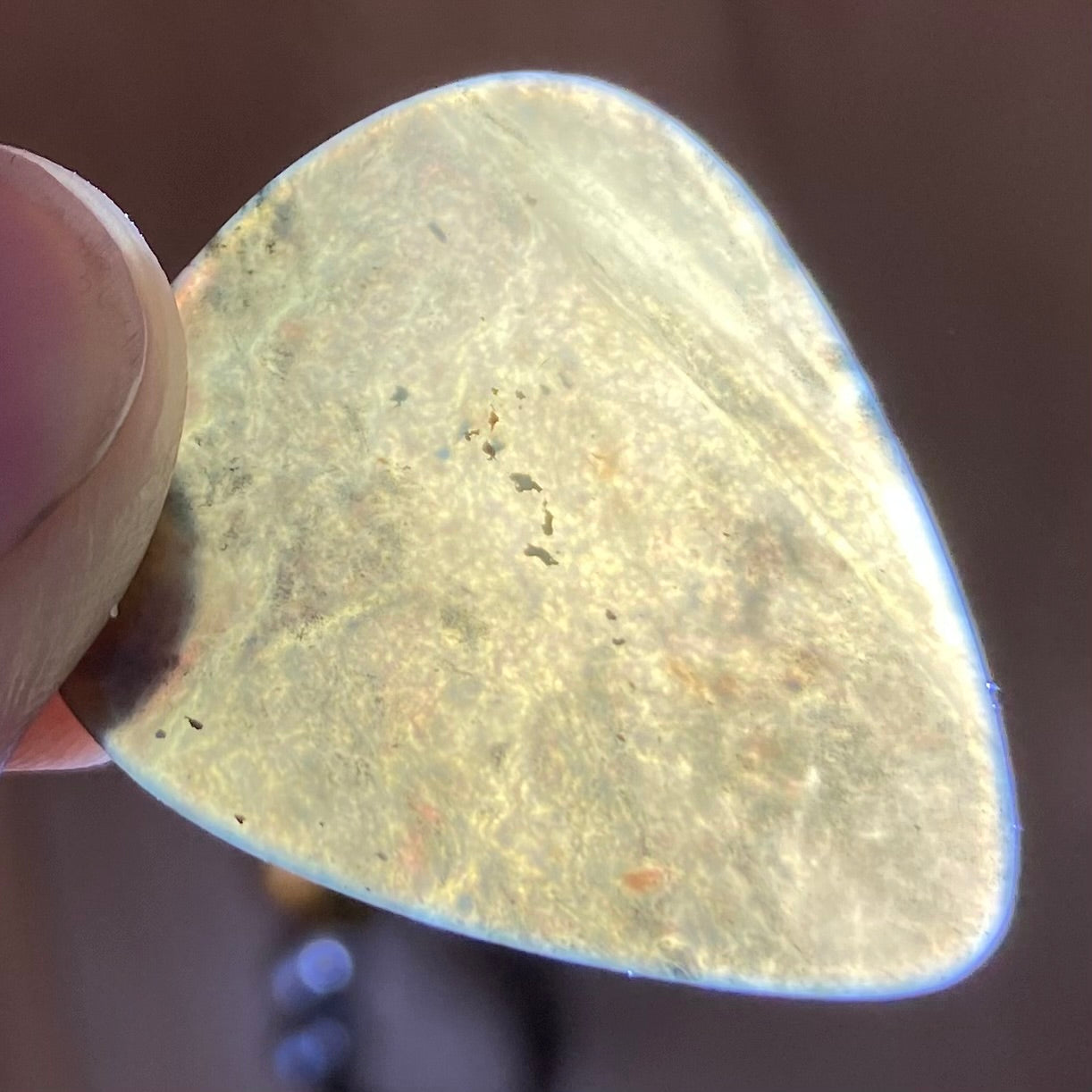 Guitar pick hand-carved from New Zealand Kawakawa Greenstone pounamu (greenstone). Translucency.