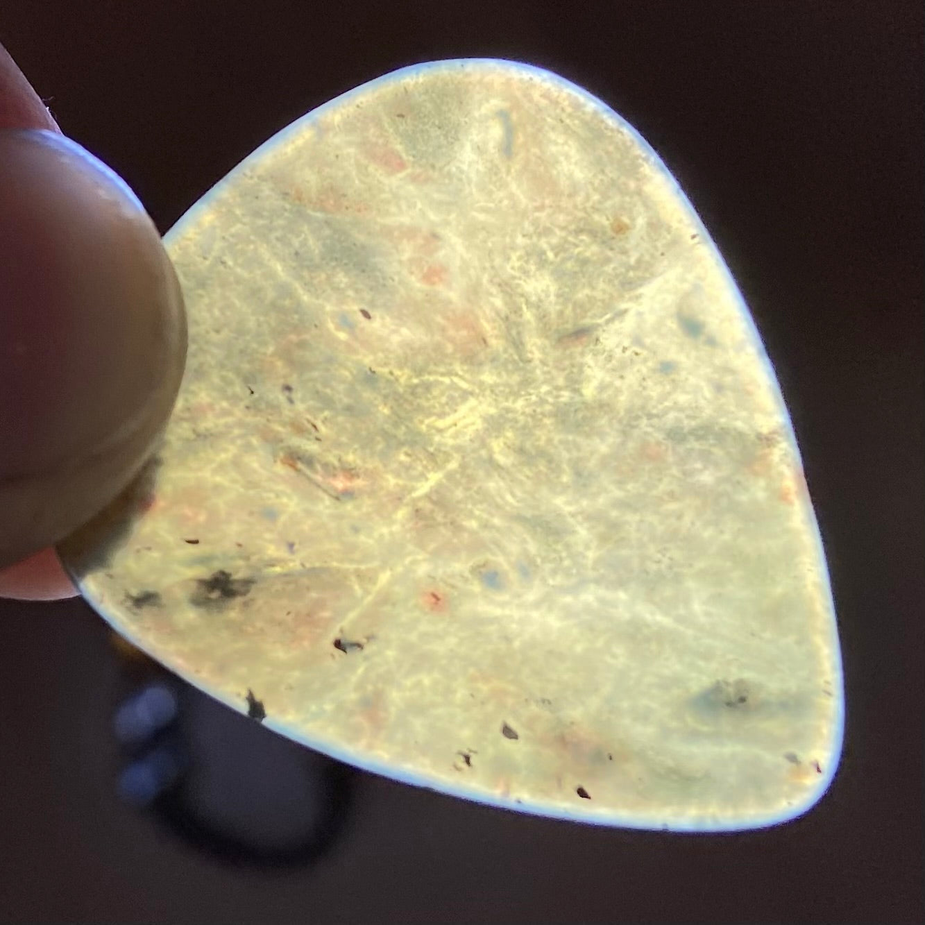 Guitar pick hand-carved from New Zealand Kawakawa Greenstone pounamu (greenstone). Translucency.
