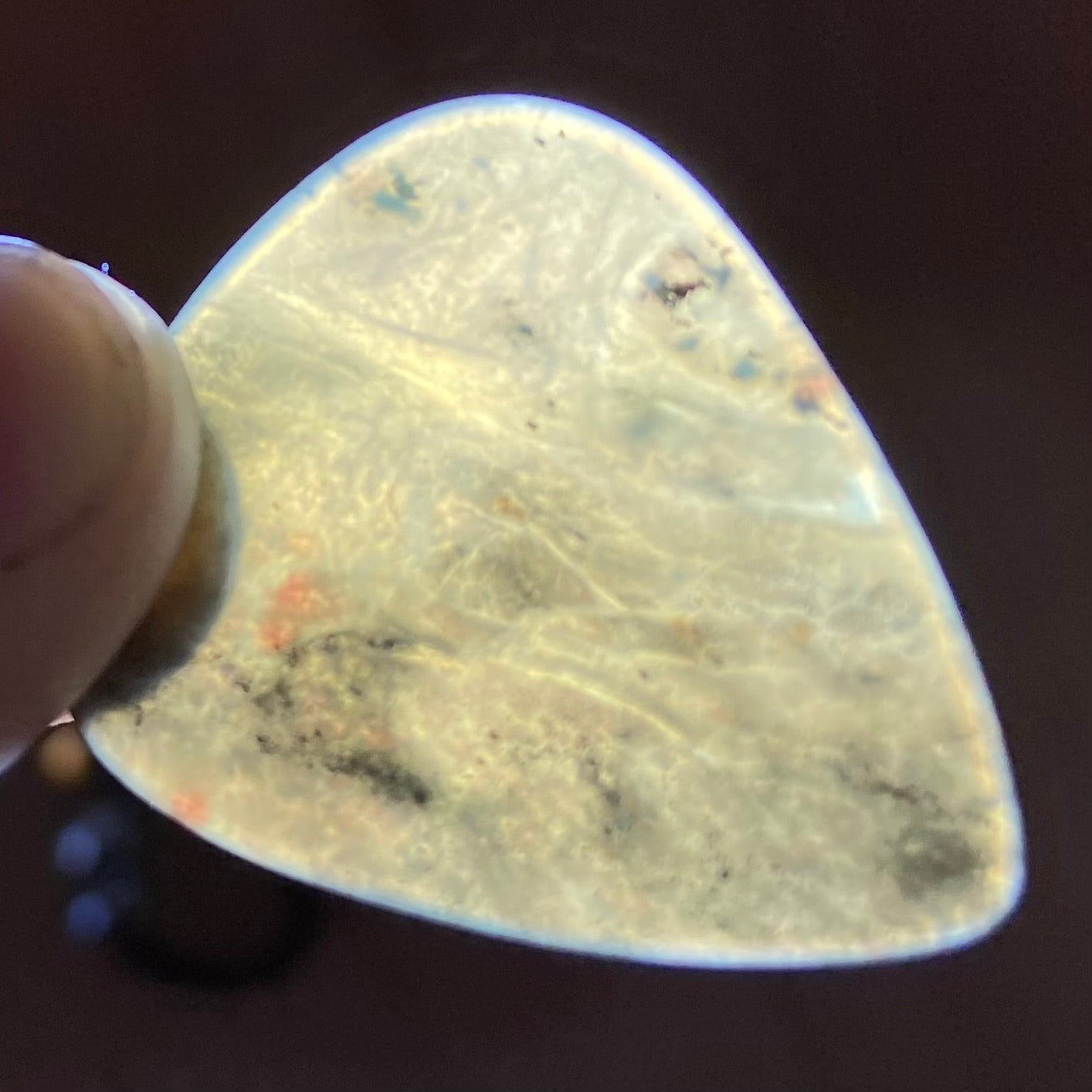 Guitar pick hand-carved from New Zealand Kawakawa Greenstone pounamu (greenstone). Translucency.