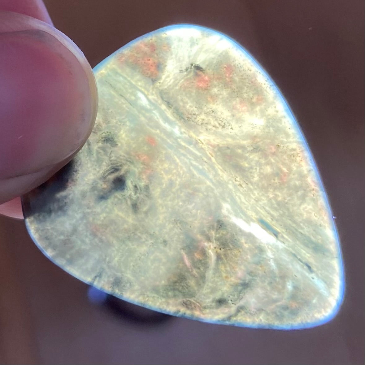 Guitar pick hand-carved from New Zealand Kawakawa Greenstone pounamu (greenstone). Translucency.