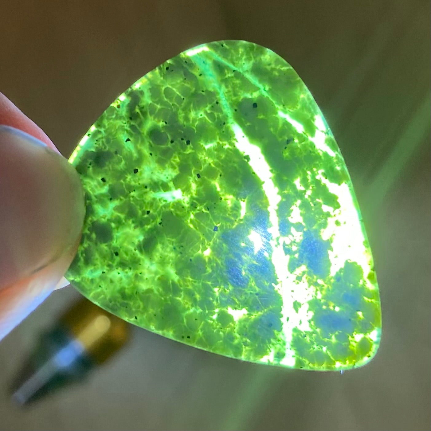 Guitar pick hand-carved from New Zealand tangiwai pounamu (greenstone). Translucency.