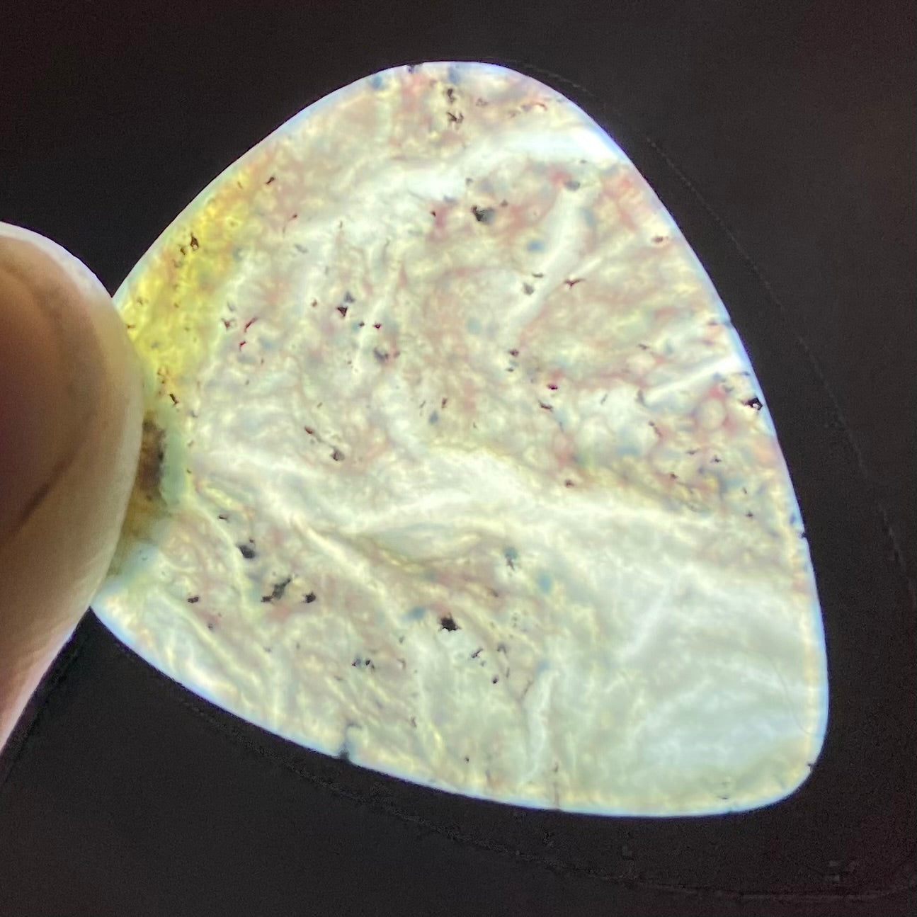 Guitar pick hand-carved from New Zealand Kawakawa Greenstone pounamu (greenstone). Translucency.