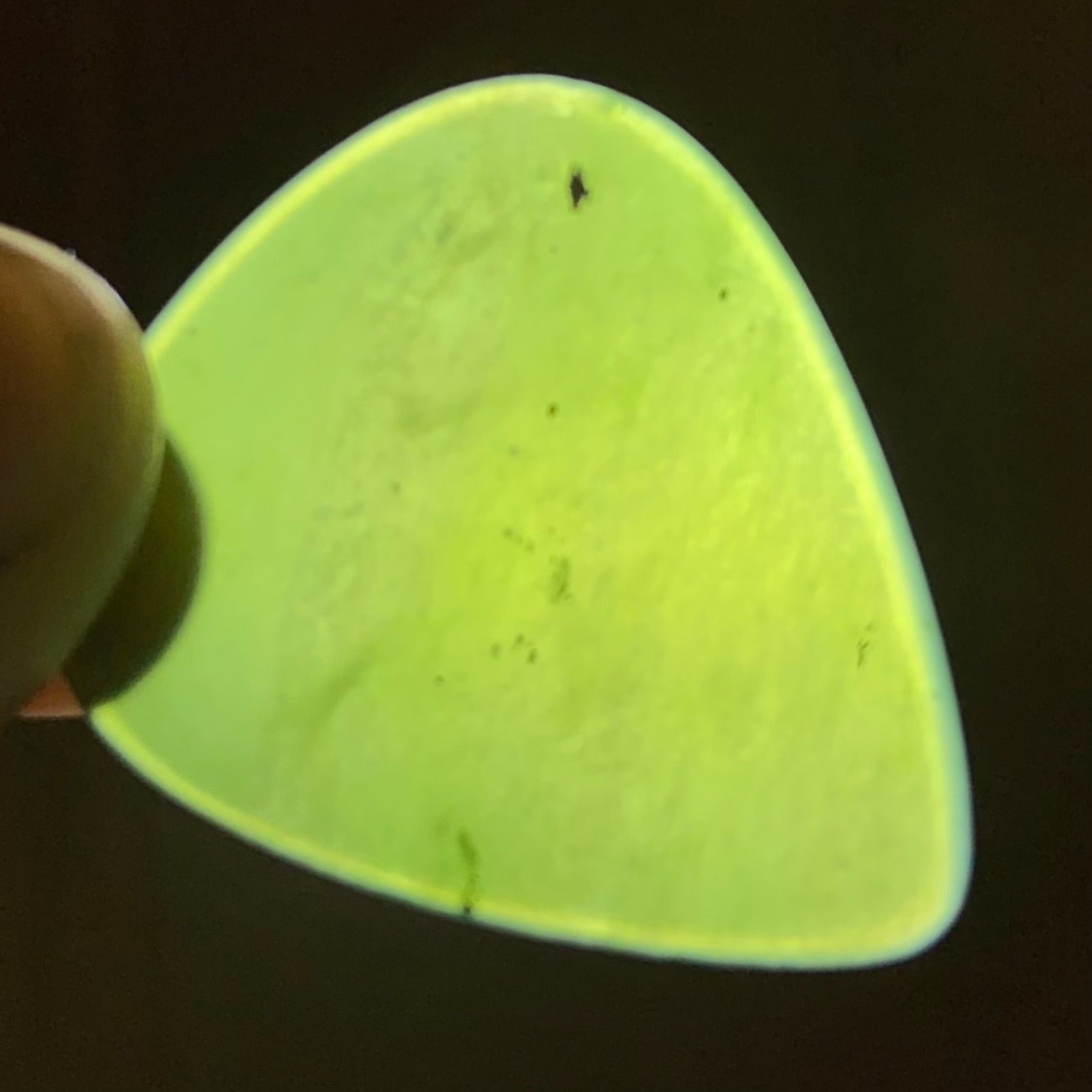 Guitar pick hand-carved from New Zealand Kahurangi Greenstone pounamu (greenstone). Translucency.