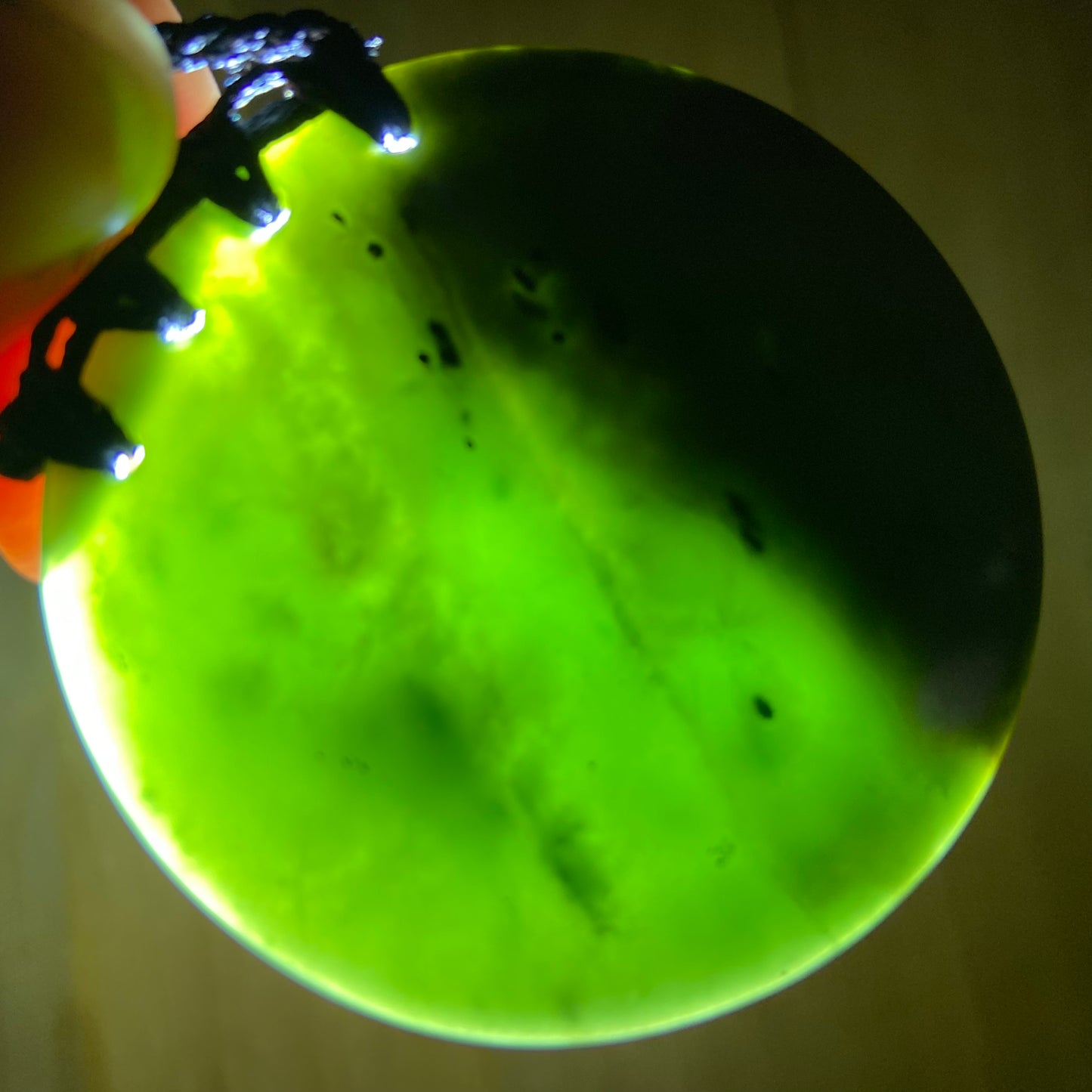 Pounamu porohita, disc, circle of life pendant from New Zealand Kawakawa pounamu (greenstone). Translucency.