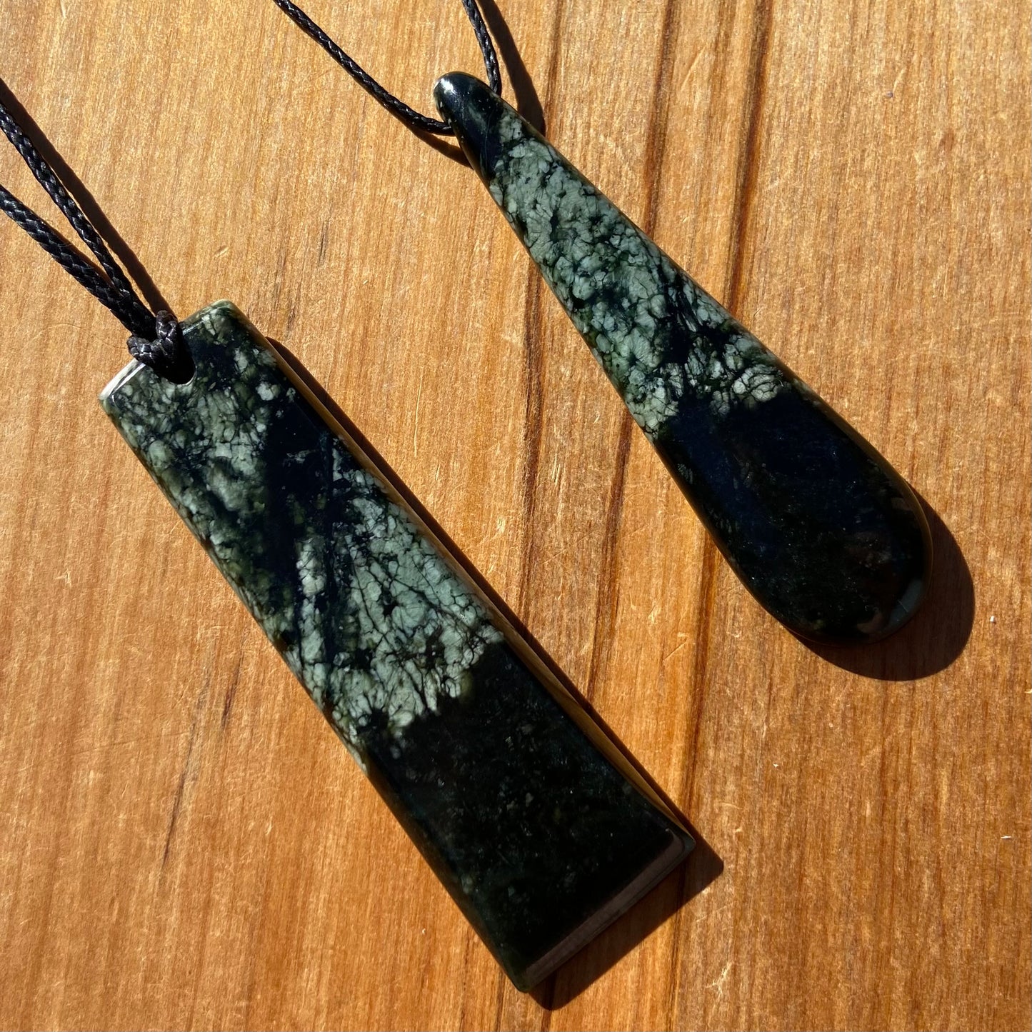 Toki and roimata pendant set hand-carved from New Zealand tangiwai pounamu. Front