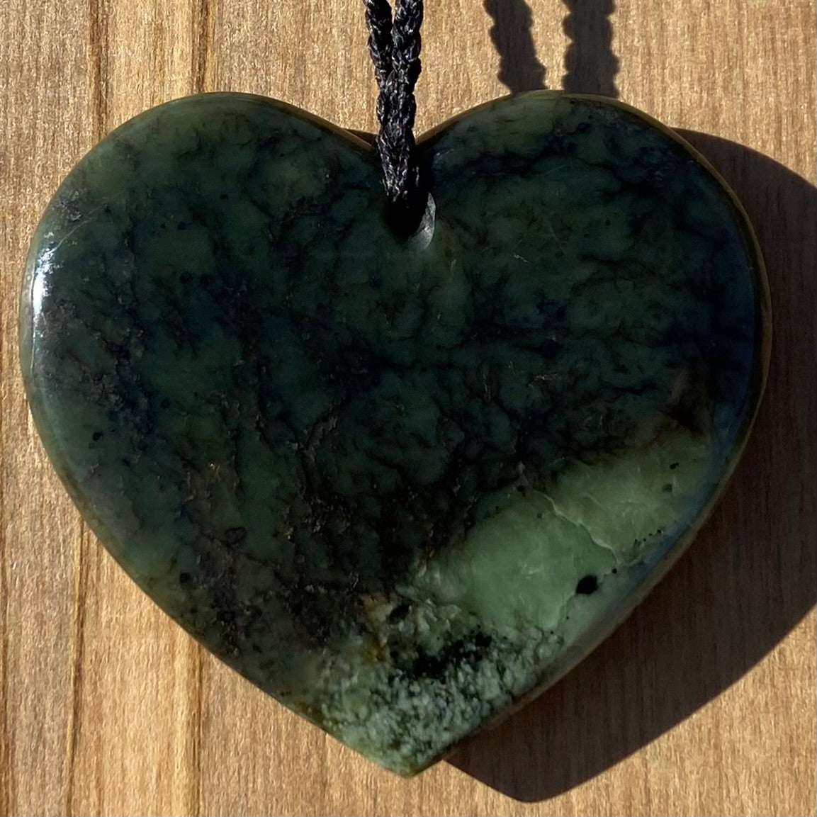 Heart pendant hand-carved from New Zealand kawawkawa pounamu (greenstone). Back.