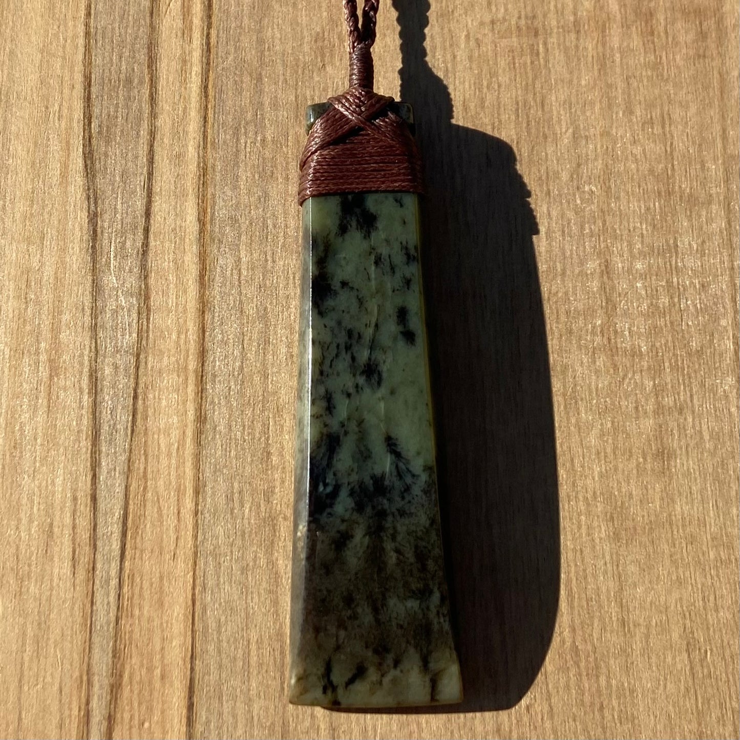 Toki pendant hand-carved from New Zealand kokopu pounamu (greenstone). Front.