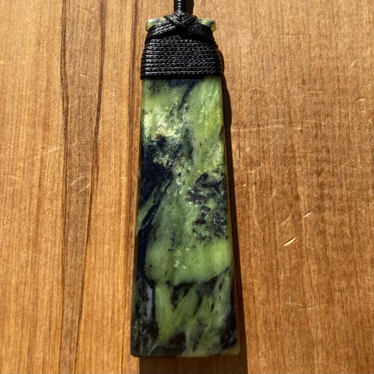 Bound toki pendant hand-carved from New Zealand Douglas Creek pounamu (greenstone). Front.