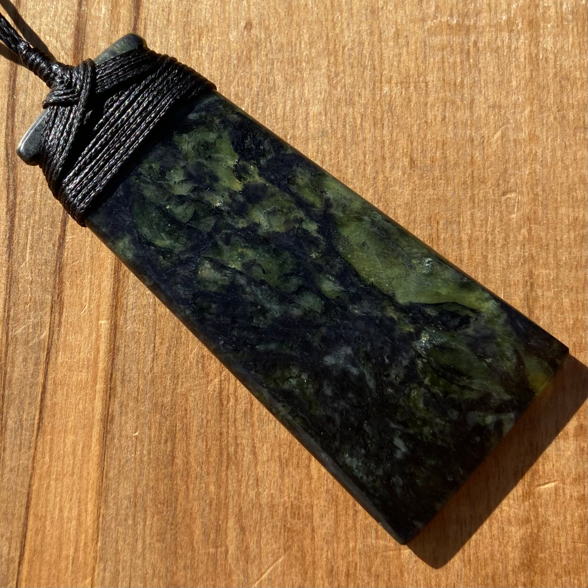 Bound toki pendant hand-carved from New Zealand Douglas Creek pounamu (greenstone). Back.